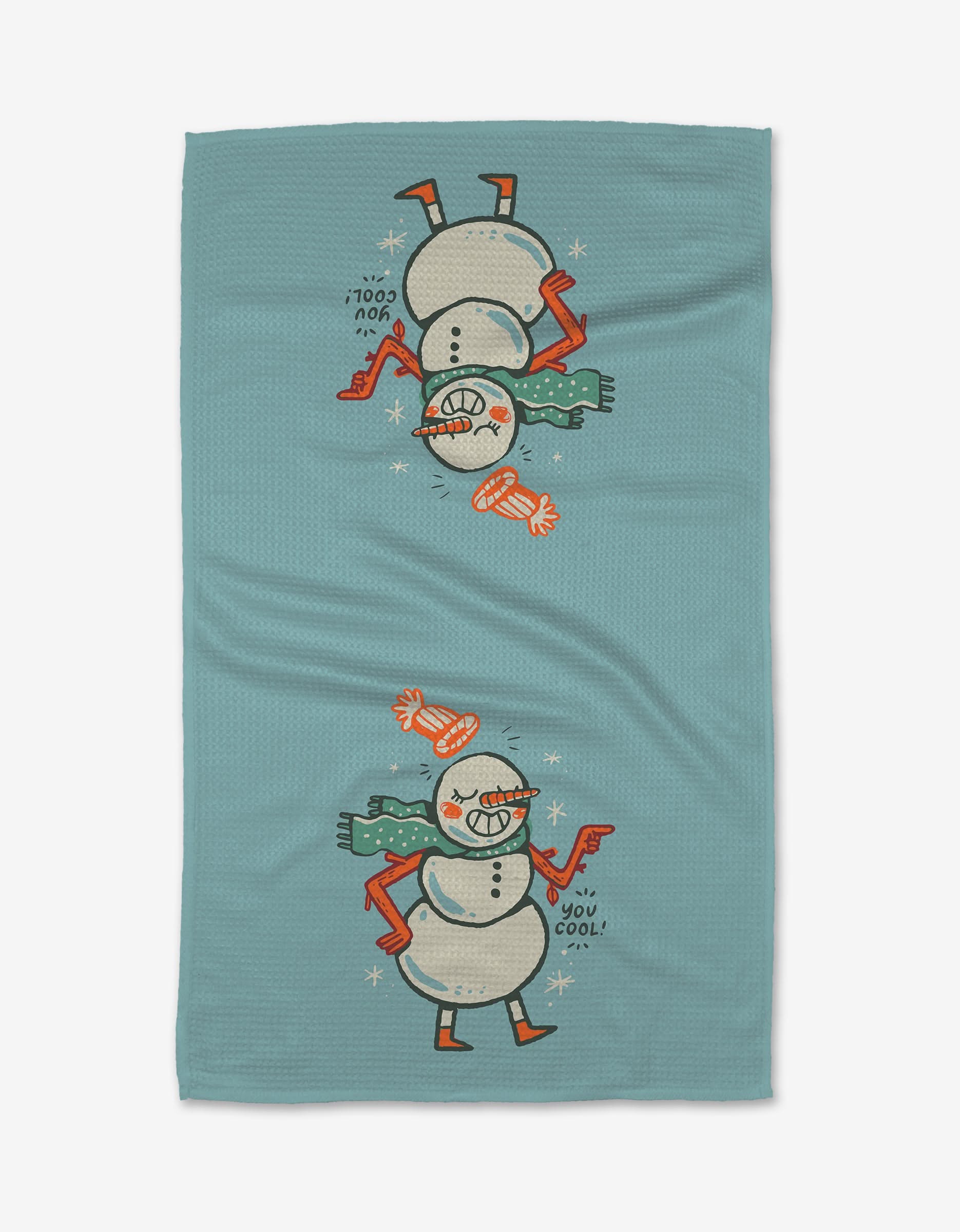 The Carly Berry You Cool tea towel in blue, made from recycled materials, shows a playful cartoon snowman in a red hat, scarf, and gloves—both right-side-up and upside-down—above the phrase You cool!.