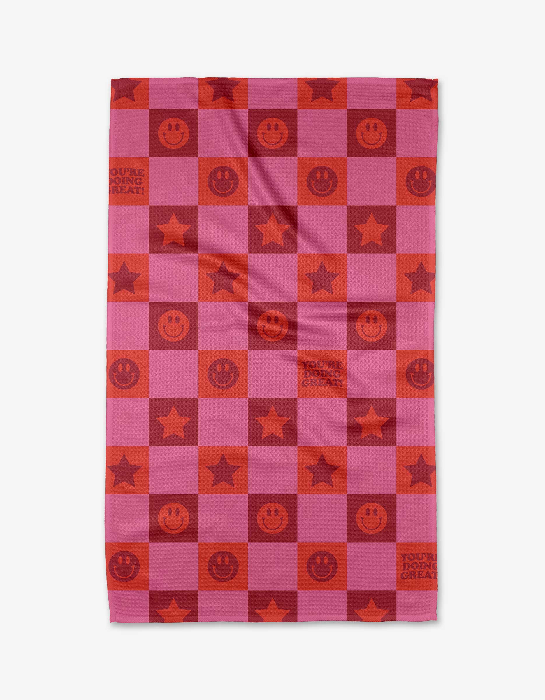 The Youre Doing Great tea towel by Quotes by Christie features a pink and red checkerboard design with smiley faces, stars, and motivational text. Made from recycled materials for an eco-friendly touch.