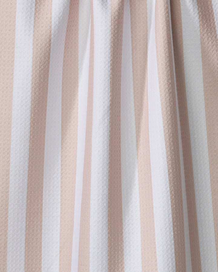Close-up of the Kailee Wright Yvonne Stripe kitchen towel, featuring vertical beige and white stripes, a slightly textured surface, gentle folds, and crafted from recycled materials.
