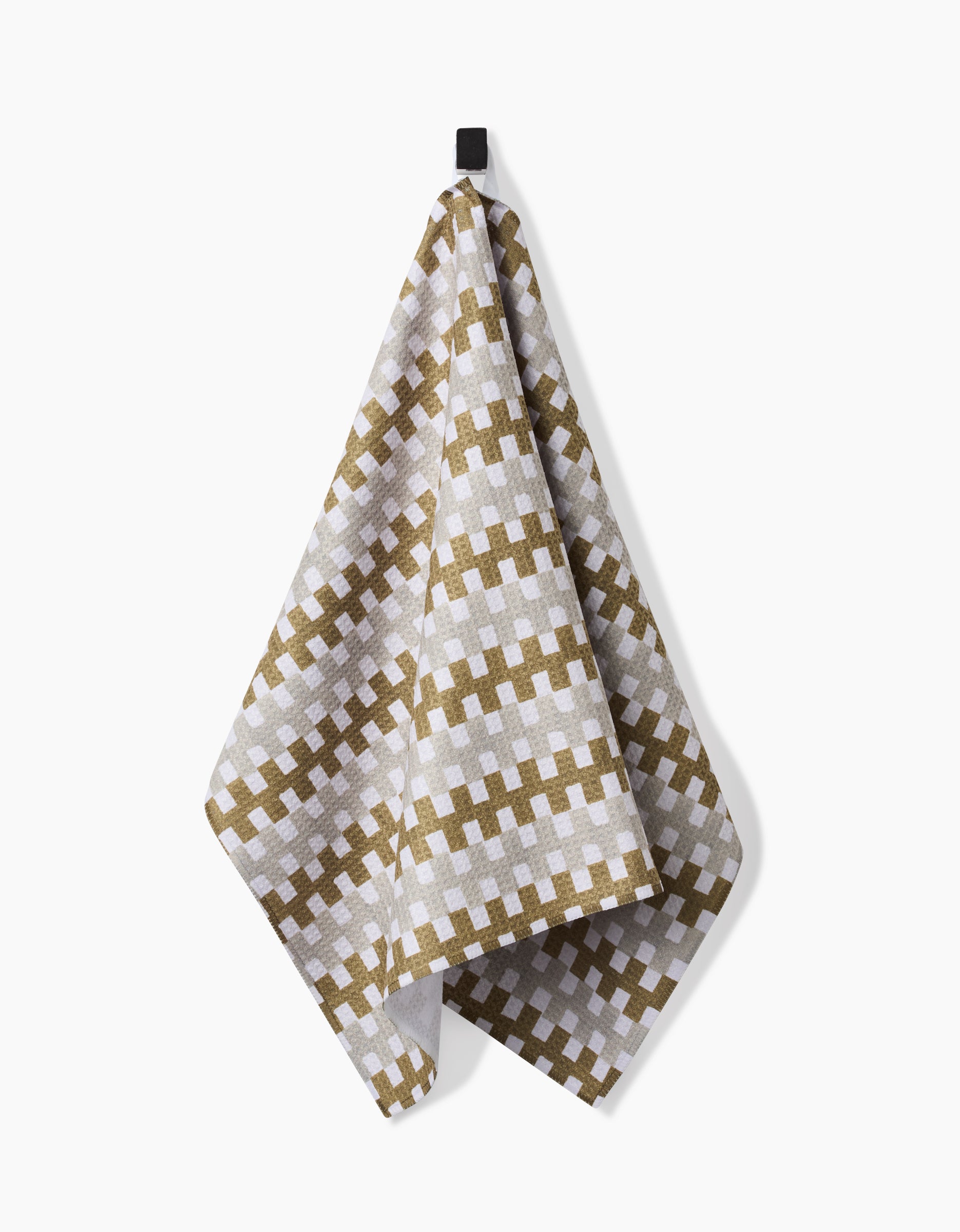 The Studio Jeannot Zippy dish towel, featuring a brown and white checkered pattern, hangs from a black loop against a plain white background.