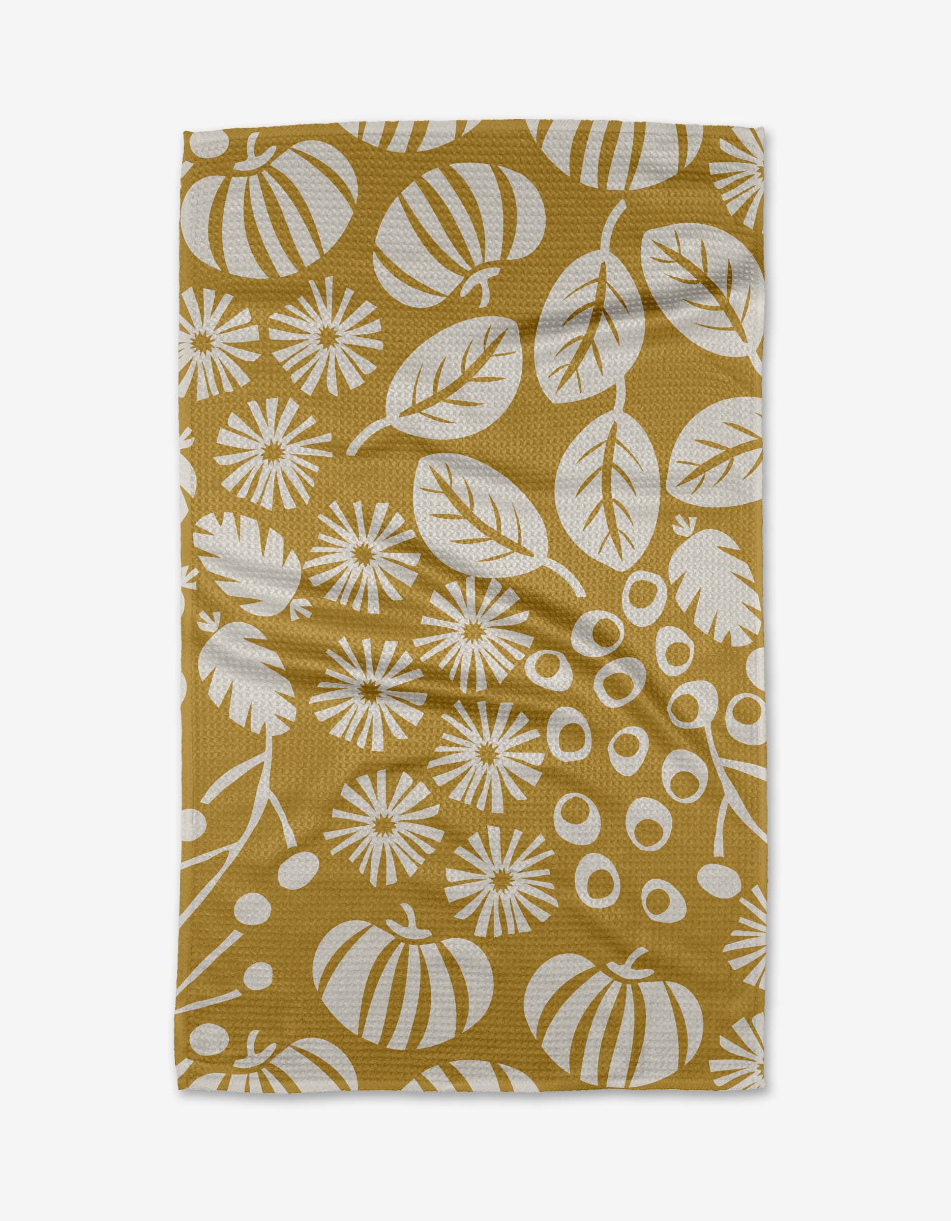Harvest Toss by Lizzie Clark is a mustard yellow Tea Towel made from Geoweave™ fabric with recycled materials, featuring a white botanical and pumpkin pattern. The slightly wrinkled towel is shown on a white background.