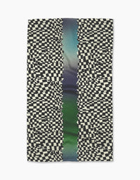 Geometrys Current dish towel is rectangular and ultra-absorbent, featuring a distorted black-and-white checkerboard pattern on both sides with a central vertical stripe in blended green, blue, and purple tones.