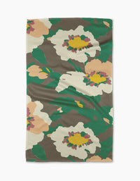 The Darla tea towel by Geometry features bold abstract florals and leaves in green, white, beige, yellow, and pink on a brown background. Made from quick-drying recycled materials for convenience.
