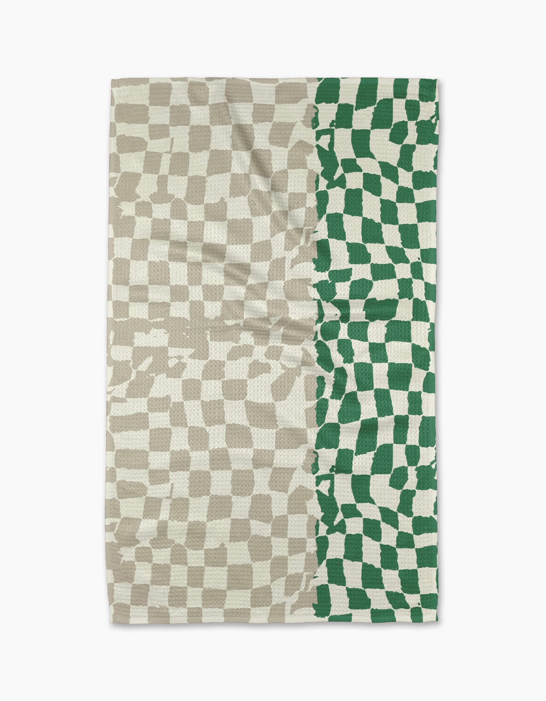 The Dual tea towel by Geometry features a wavy checkerboard pattern: beige and off-white cover the left three-quarters, while green and off-white fill the right quarter. Made from slightly wrinkled fabric, it blends style with practicality.