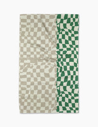 The Dual tea towel by Geometry features a wavy checkerboard pattern: beige and off-white cover the left three-quarters, while green and off-white fill the right quarter. Made from slightly wrinkled fabric, it blends style with practicality.