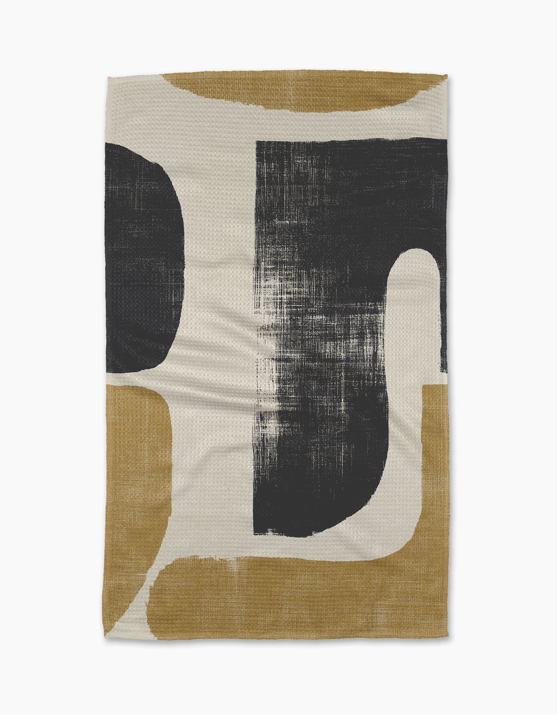 The Forma woven blanket by Geometry showcases bold black and mustard yellow curved shapes on a cream background, inspired by eco-friendly minimalist kitchen towels.