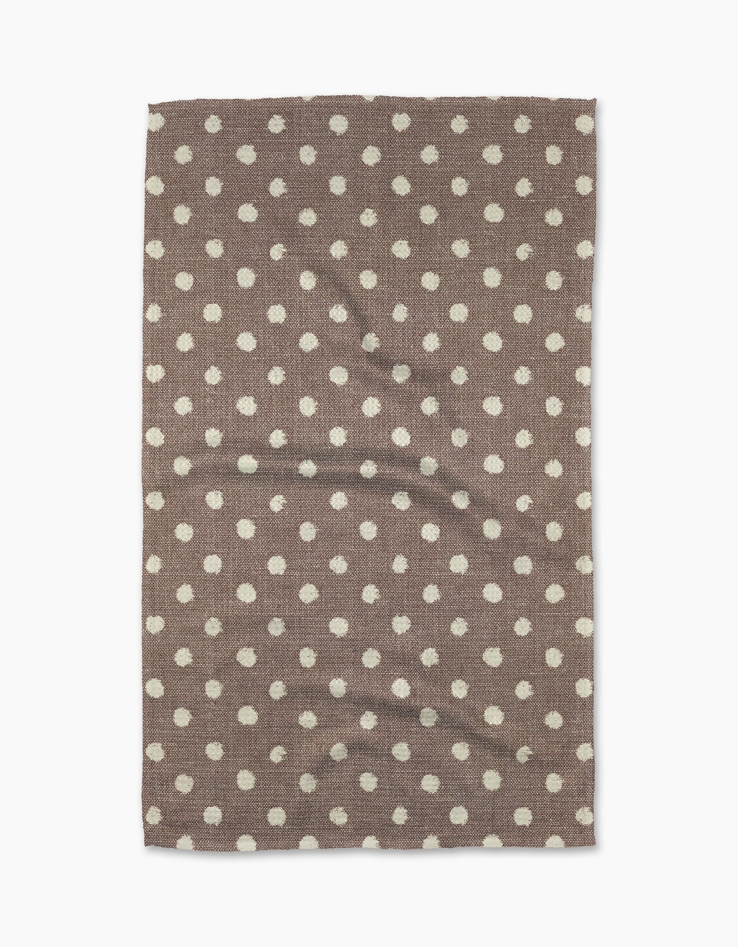 The Freckle Off White kitchen towel by Geometry features a rectangular eco-friendly fabric with an even white dot pattern. Slightly wrinkled and brown in color, it is displayed on a white background.