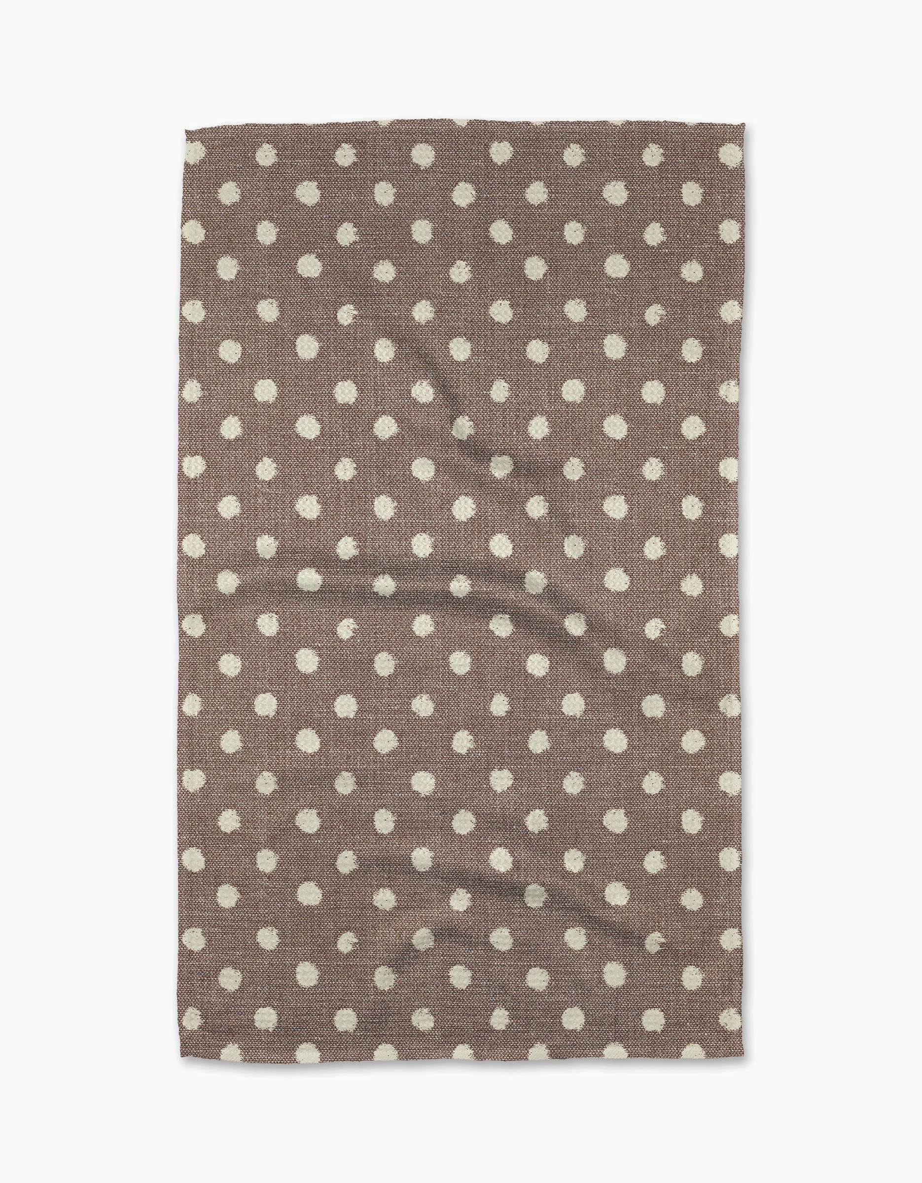 The Freckle Off White kitchen towel by Geometry features a rectangular eco-friendly fabric with an even white dot pattern. Slightly wrinkled and brown in color, it is displayed on a white background.