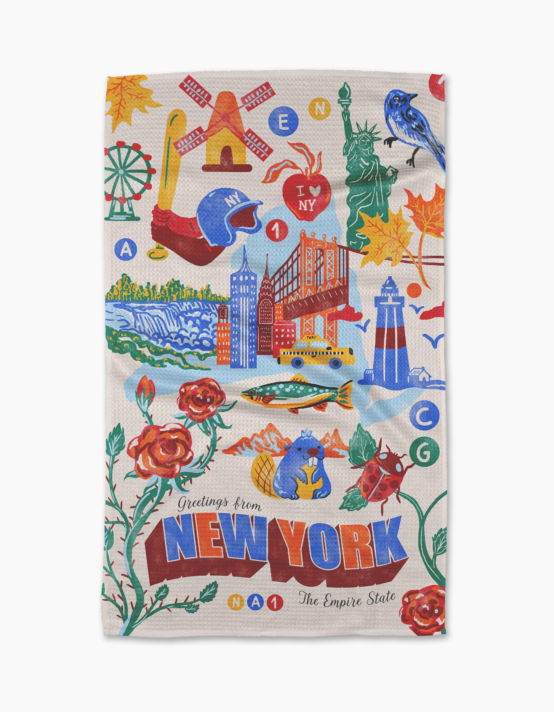 Geometry’s “Greetings From New York” tea towel showcases the Statue of Liberty, NYC skyline, taxi, autumn leaves, roses, a bluebird, I Love NY heart, and “Greetings from NEW YORK, The Empire State.”.