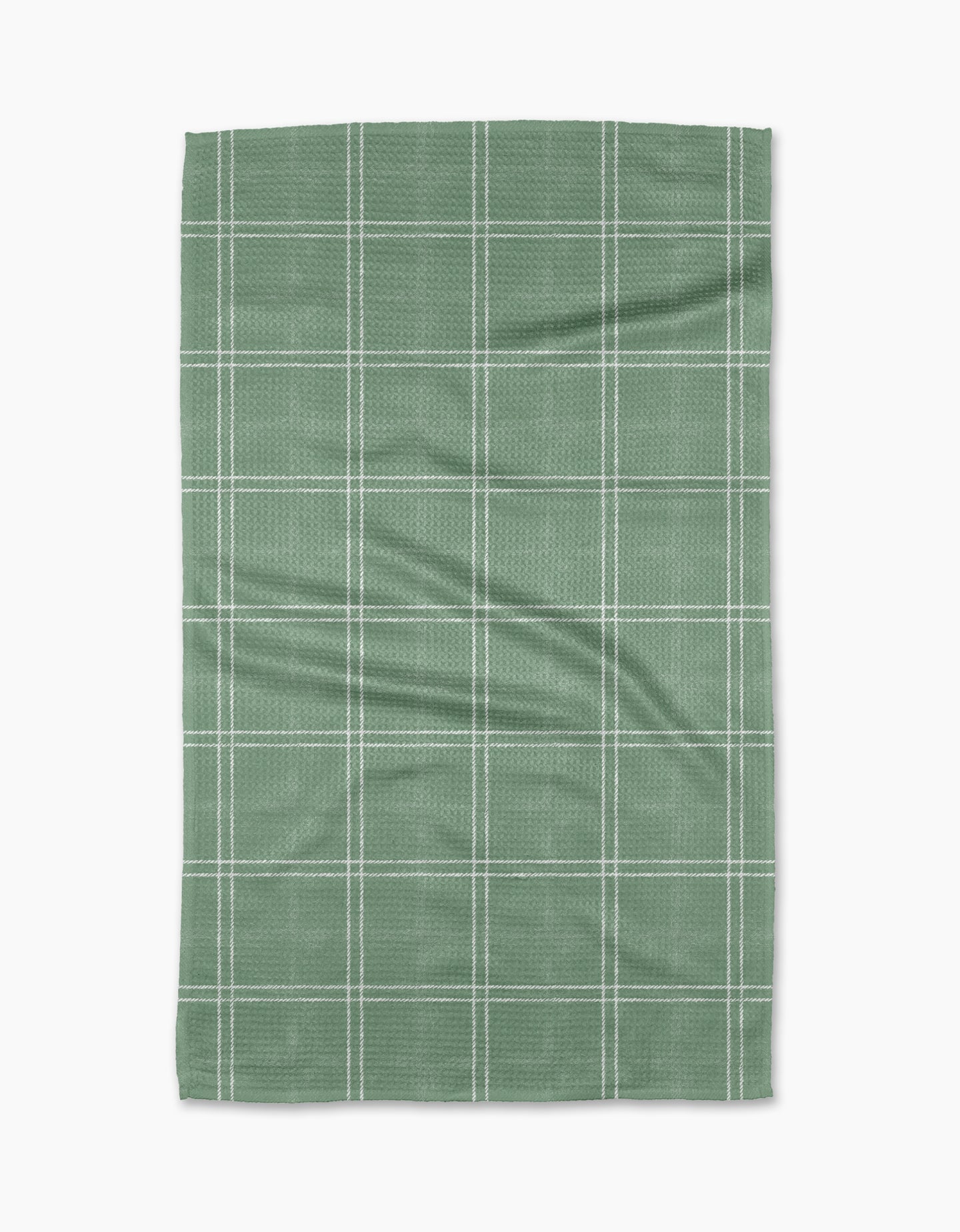 The Geometry Hearth Meadow is a green rectangular tea towel made from recycled materials, featuring a white grid pattern of evenly spaced lines and displayed flat on a white background.