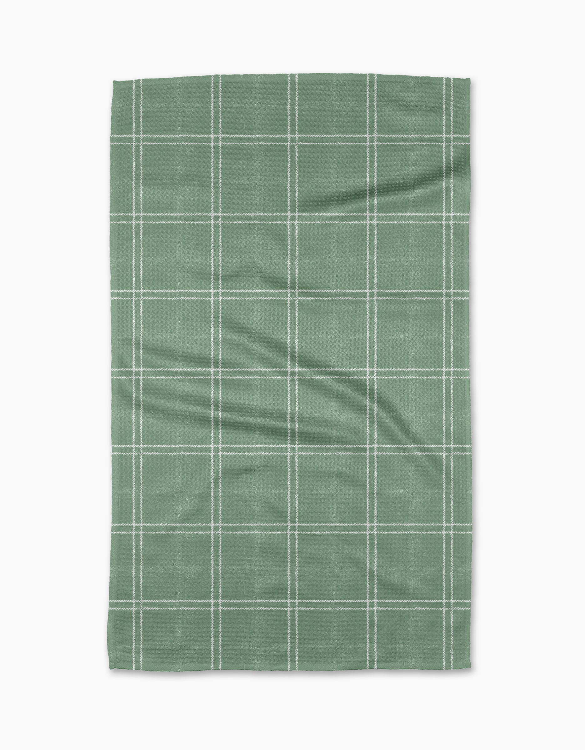 The Geometry Hearth Meadow is a green rectangular tea towel made from recycled materials, featuring a white grid pattern of evenly spaced lines and displayed flat on a white background.