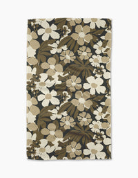 The Marlo Brown tea towel by Geometry is rectangular, made from recycled materials, and features beige, brown, and cream floral patterns on a dark background, shown flat against a white surface.