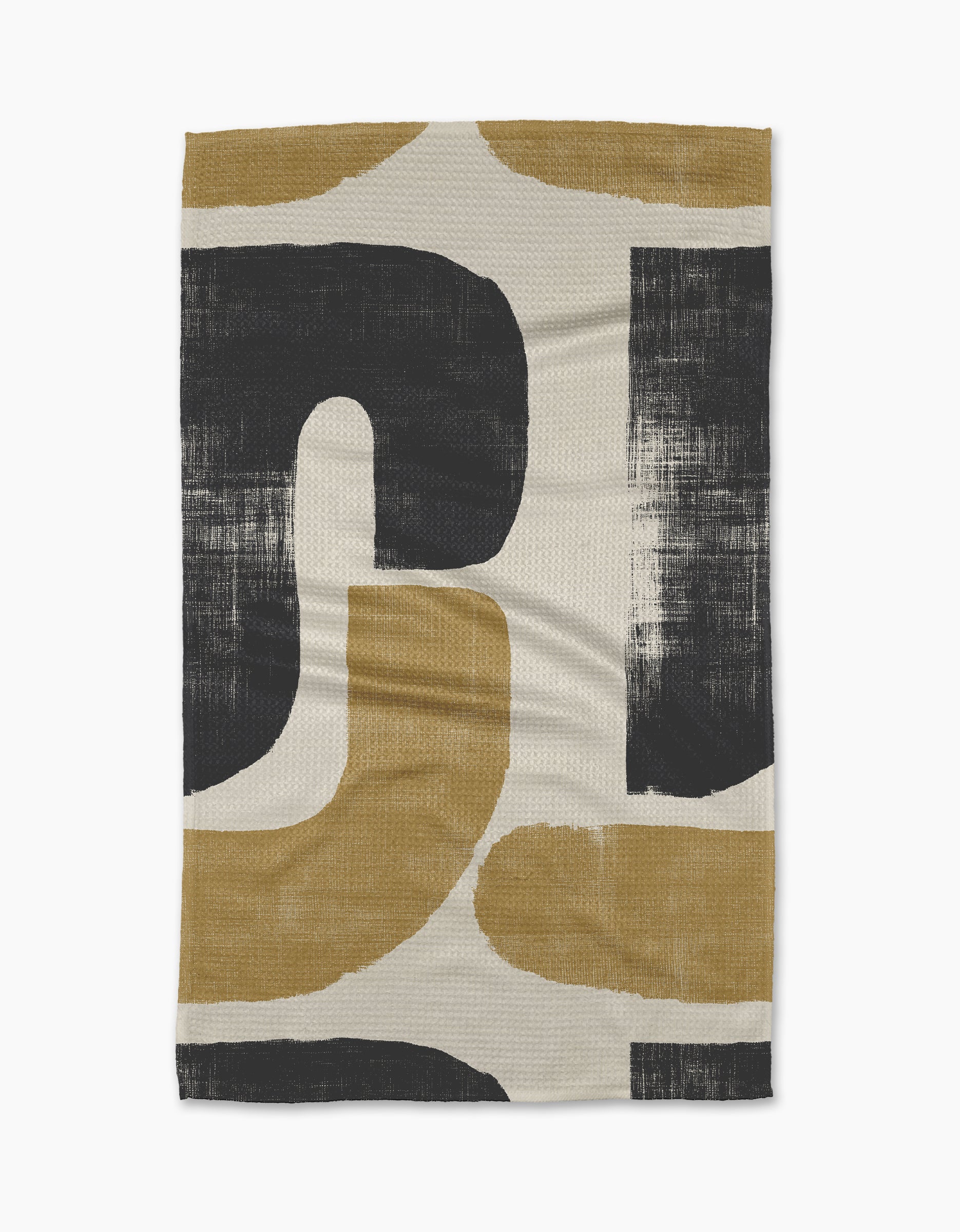 The Geometry Mono tea towel is ultra-absorbent and features a bold, abstract pattern with large black and mustard yellow curved shapes on a cream background, all with a brushed, textured look.