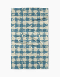 The Patch Denim tea towel by Geometry features a blue and white checkered pattern with a textured, slightly uneven design, displayed flat on a white background.
