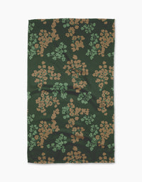 The Geometry Sonnet Forest tea towel features a rectangular shape in dark green with tan and light green floral clusters. Ultra-absorbent, it’s shown laid flat on a white background.