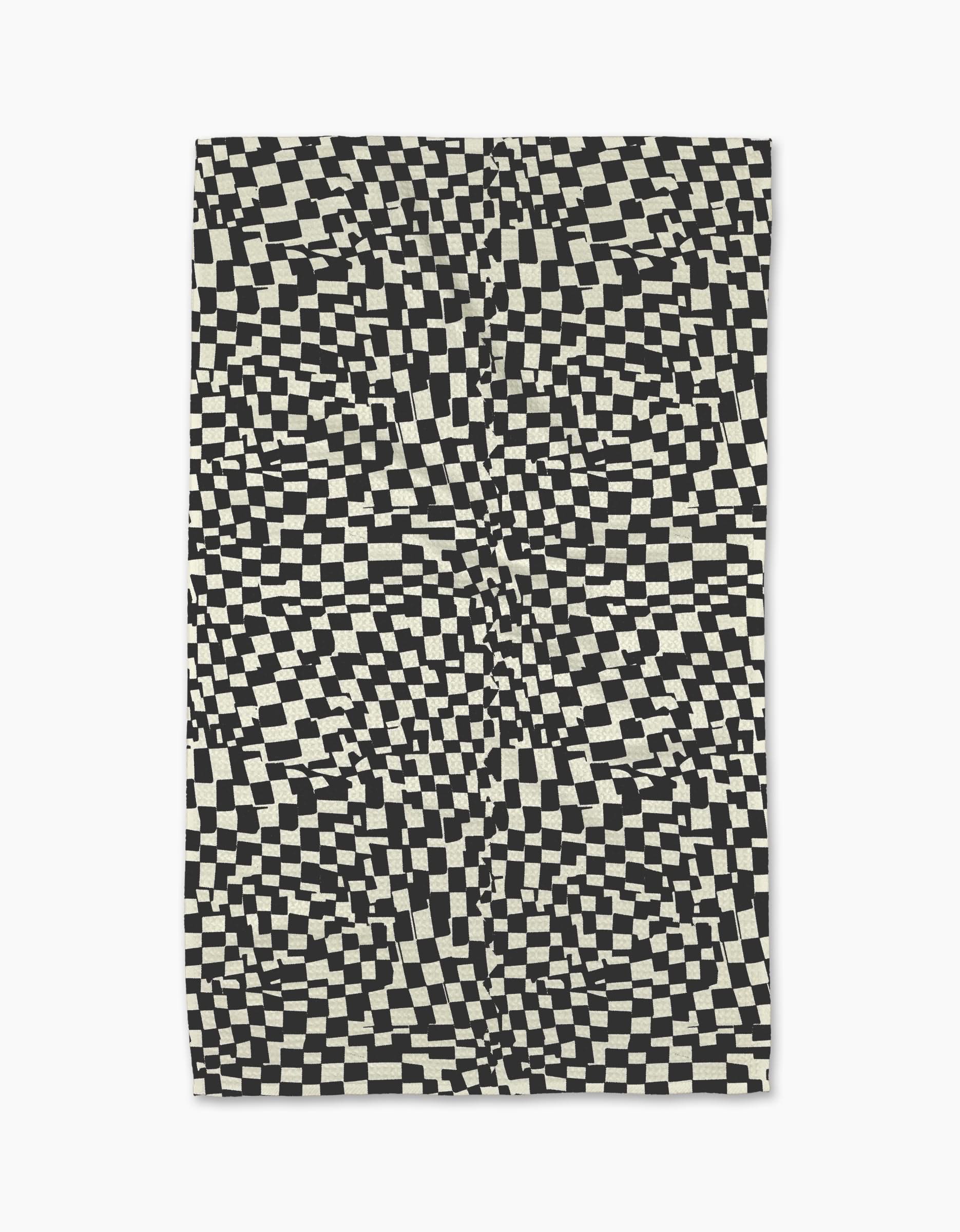 The Static rug by Geometry features a black and white distorted checkerboard pattern for an optical illusion effect—pair it with a modern, eco-friendly kitchen towel for a coordinated look.