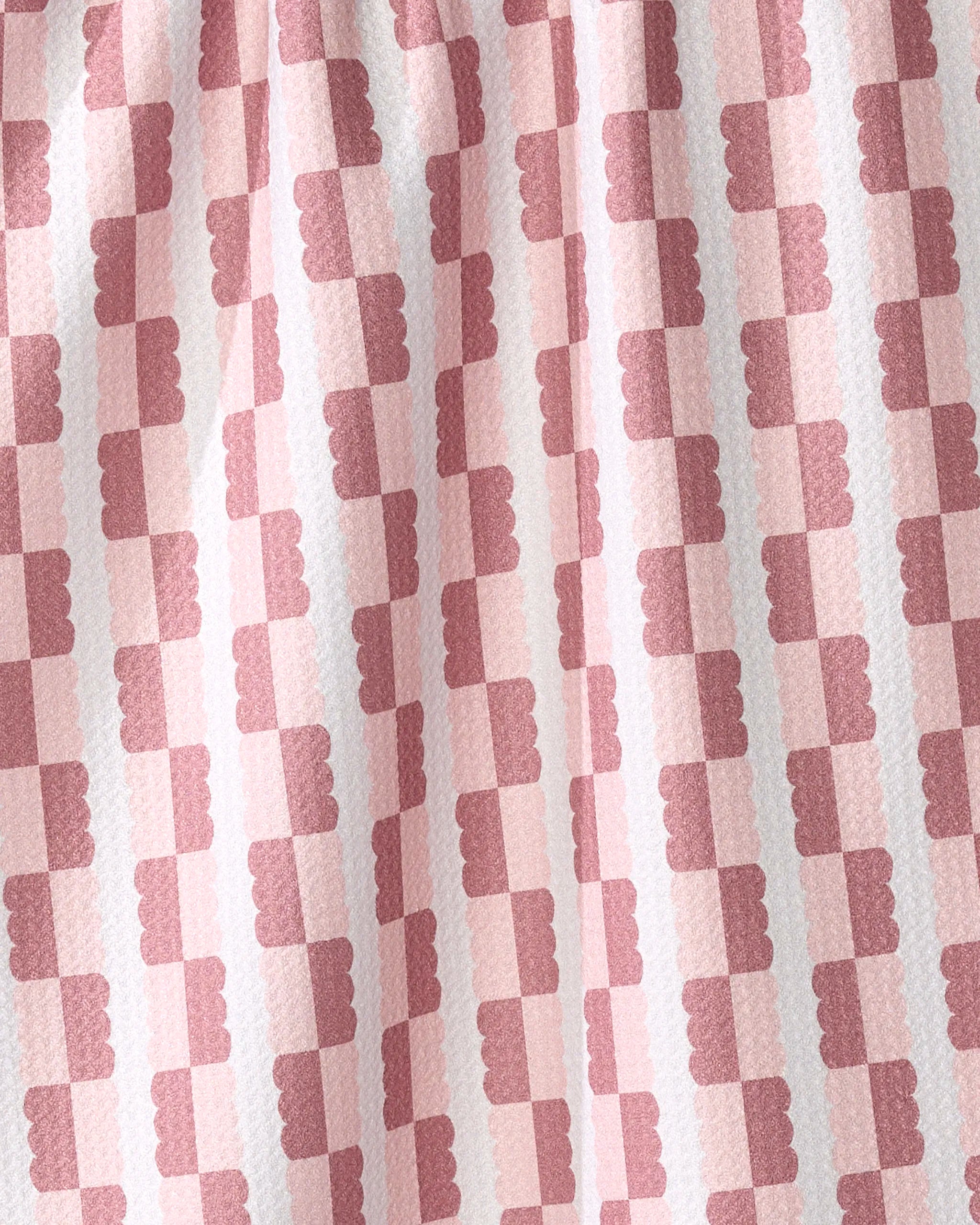 A close-up of the Brooke Homec "Sweet" kitchen tea towel, showcasing its ultra-absorbent recycled material, pink and red checkered pattern with scalloped edges on darker squares, and visible light texture.