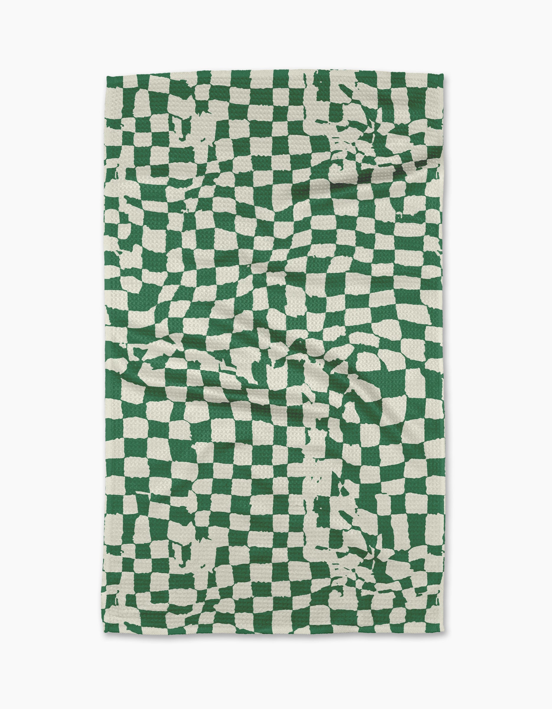 The Geometry Verdant tea towel is a rectangular, eco-friendly towel featuring a green and white distorted checkerboard with irregular lines and random splotches. Made from absorbent fabric, it’s shown slightly creased against a white background.