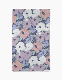 The Geometry Viola tea towel features a pastel floral design with large white, pink, and lavender flowers on a light background. Made from quick-drying, recycled materials for convenience and sustainability.