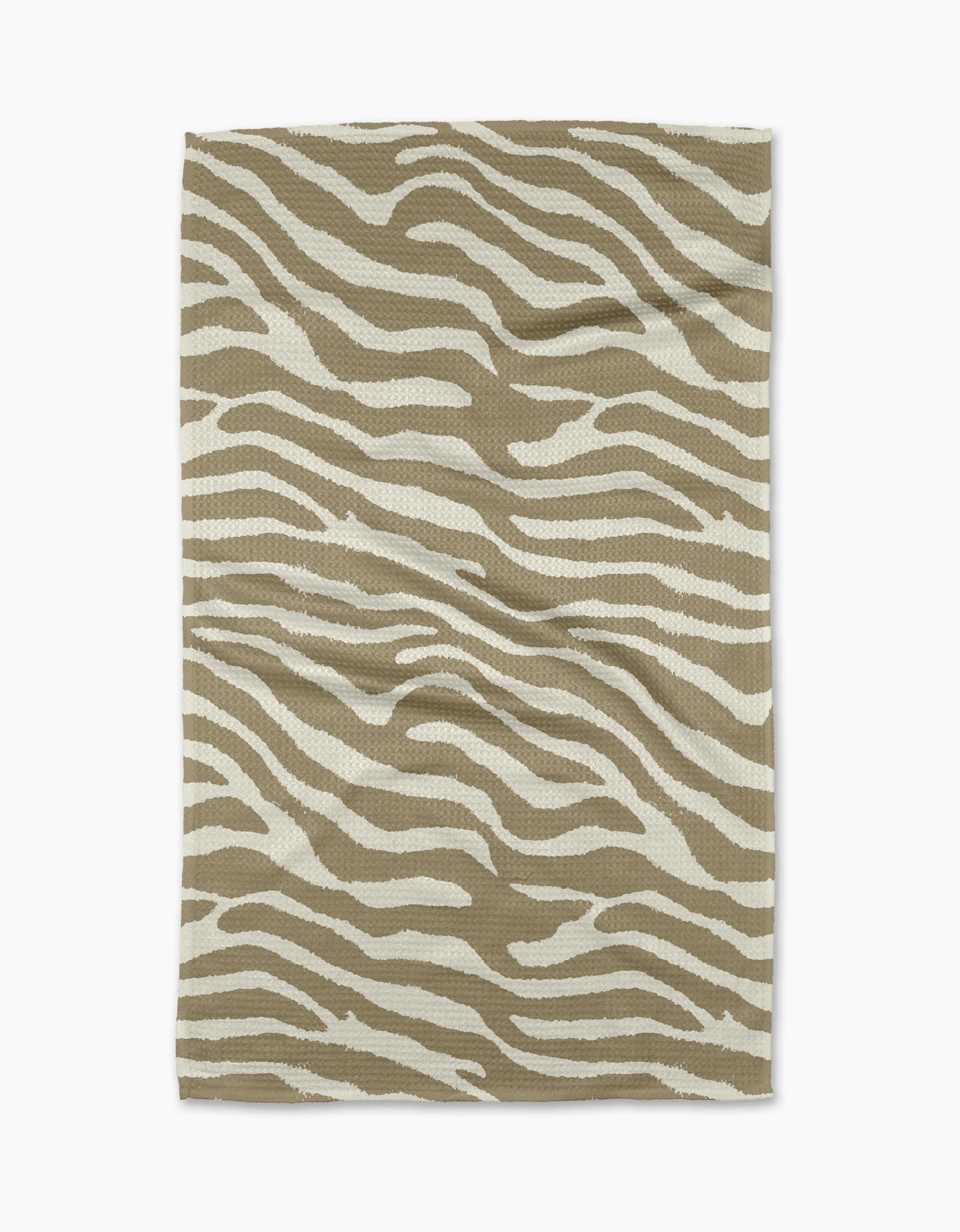 The Zira Tan tea towel by Geometry features a white zebra stripe pattern on rectangular beige fabric, displayed flat on a white background.