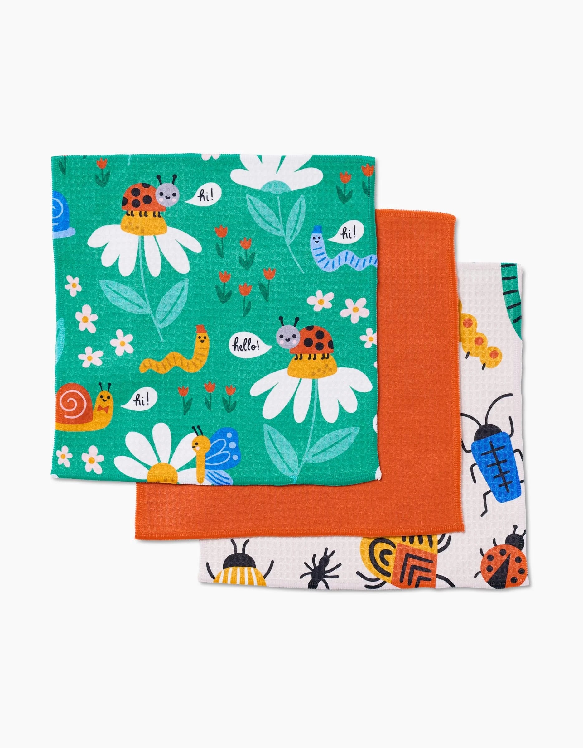 The Genna Blackburn Bugs set features three dishcloths: green with whimsical bugs and flowers, solid orange, and white with bug illustrations—all made with ultra-absorbent Geoweave for a Luxe Washcloth feel.