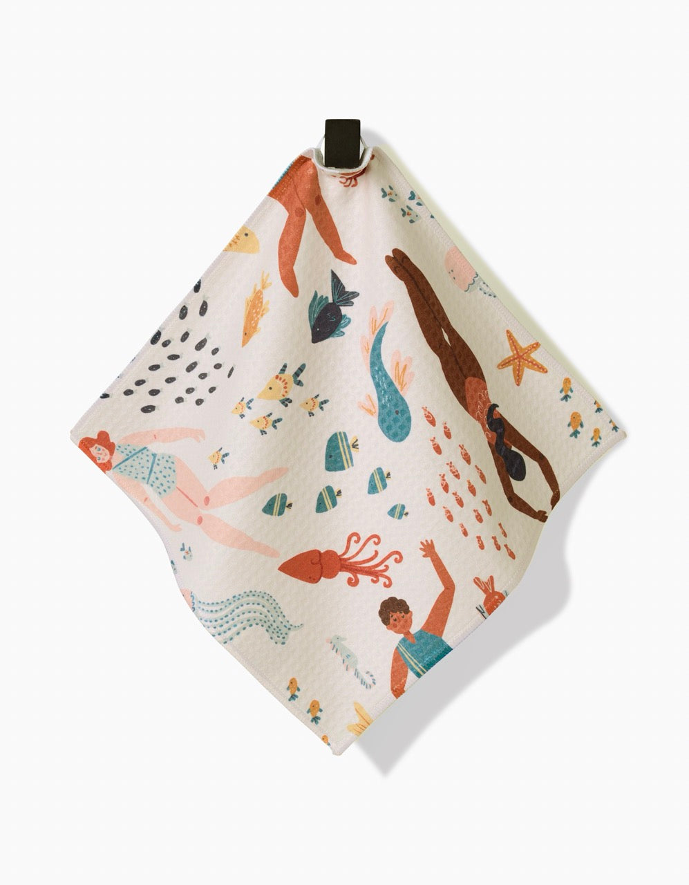 The Spirit of the Ocean napkin by Janna Sue Design features vibrant swimmers, fish, mermaids, and sea creatures on ultra-absorbent cloth—stylish and functional, with a black hanging loop and white background.