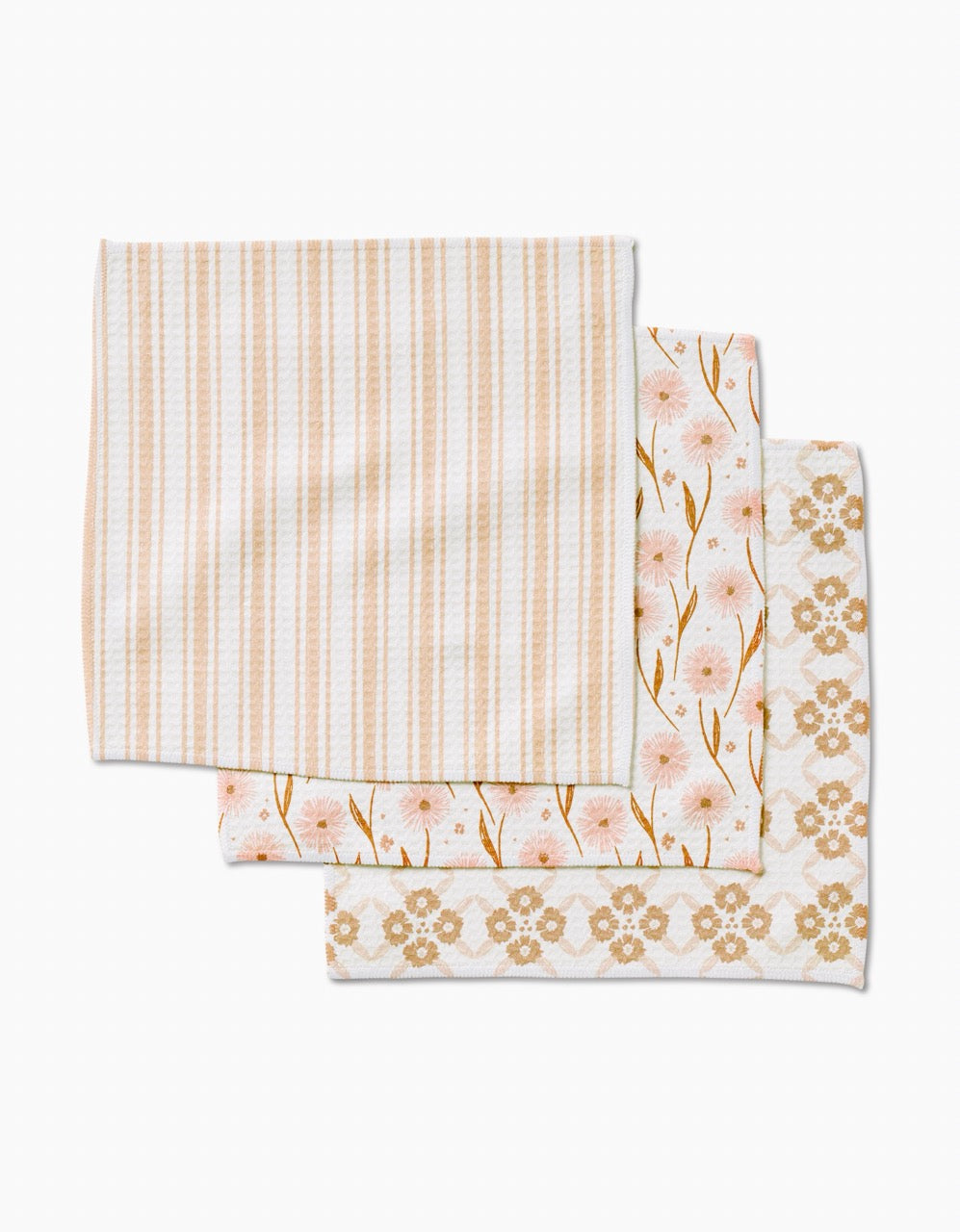 Three folded Sweet Boho Luxe Washcloths by Hufton Studio are stacked: top with beige and white stripes, middle with pink flowers and gold stems, bottom with a geometric floral motif—all in pastel tones and made from recycled materials.
