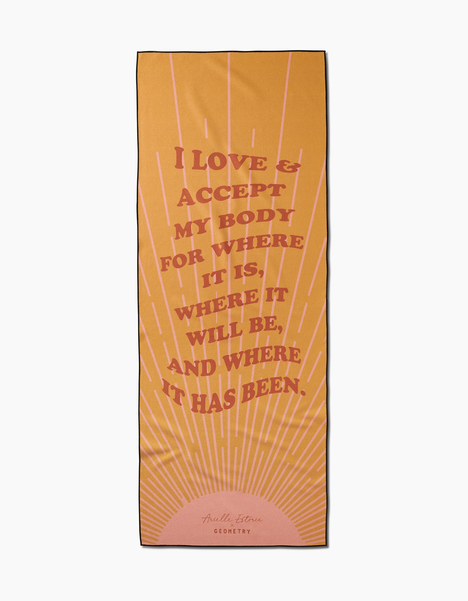 The Love and Acceptance Affirmation yoga towel by Arielle Estoria is yellow-orange, slip-resistant, features a sunburst design, and pink text: I love & accept my body for where it is, where it will be, and where it has been.