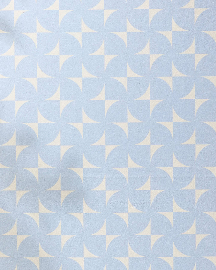 The Geometry Airy Flow yoga towel features a light blue and white geometric pattern with repeating circular and star-like shapes, creating a stylish, tiled design for an eco-friendly and comfortable practice.
