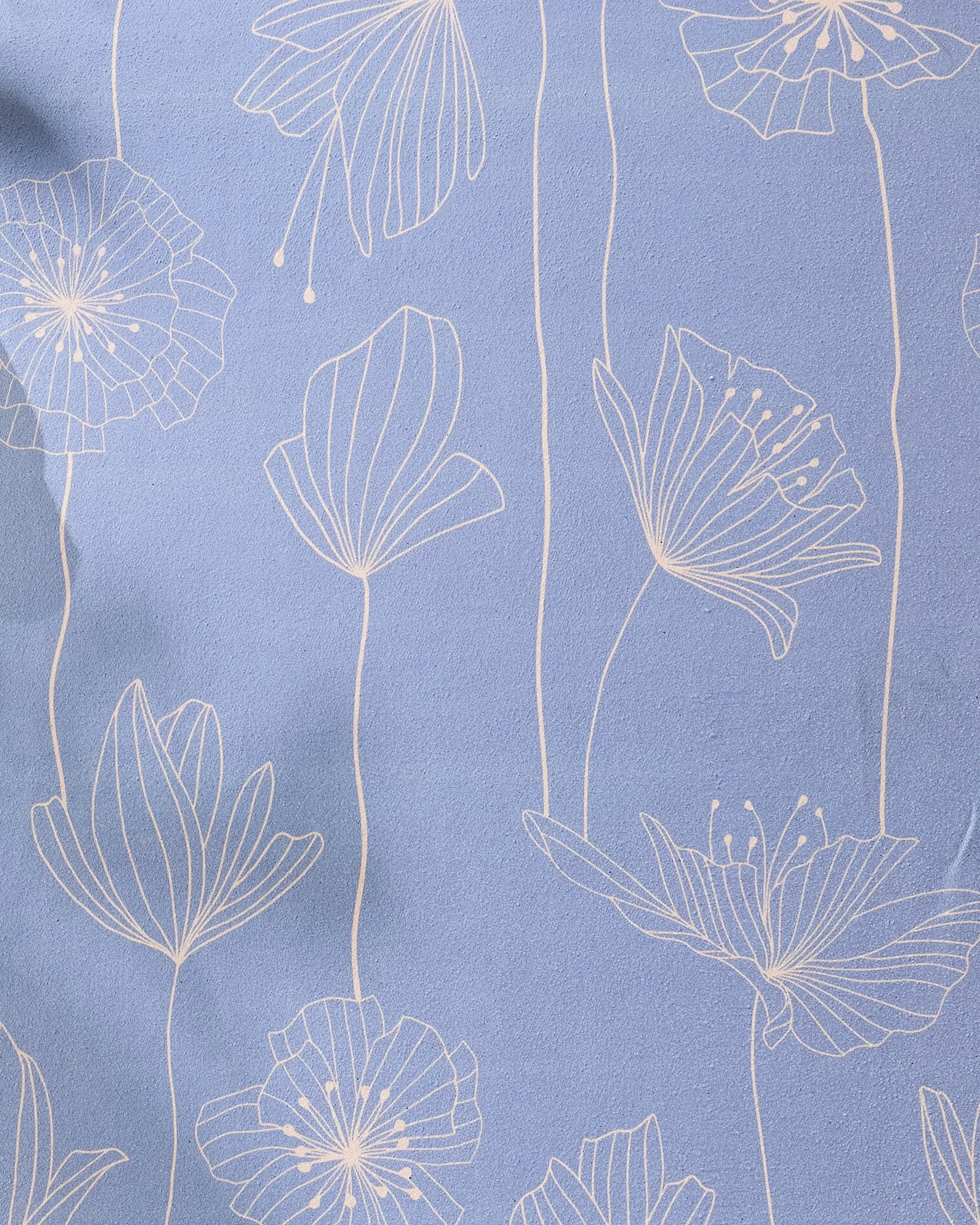 The GEOMETRY Alexa yoga towel is light blue, made from recycled materials, and features a white minimalist line-drawing floral pattern with abstract flowers and long stems across the surface.