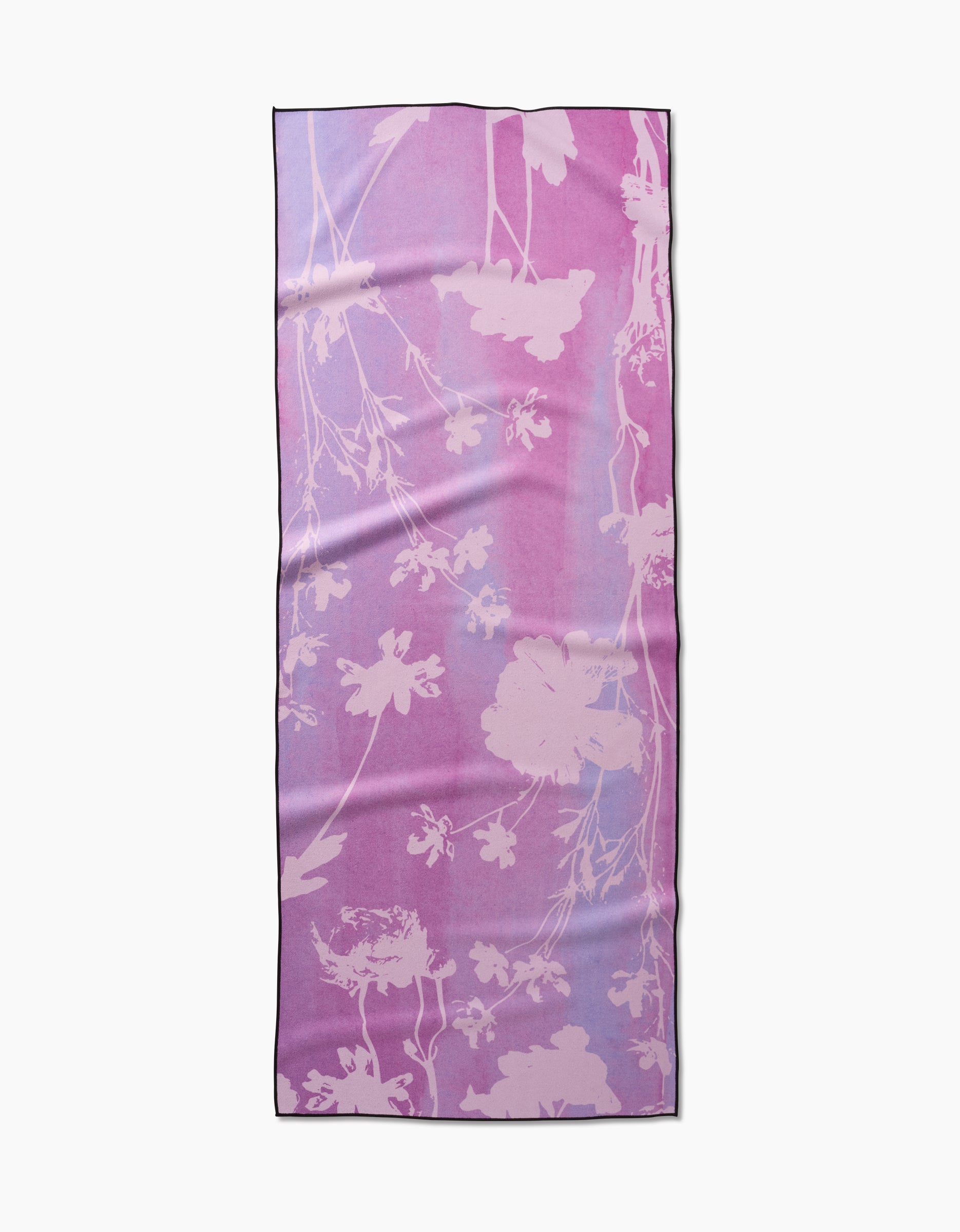 The GEOMETRY Bloom Blend is a rectangular scarf with a pink and purple gradient background, adorned with a light floral silhouette pattern throughout, crafted from recycled materials.
