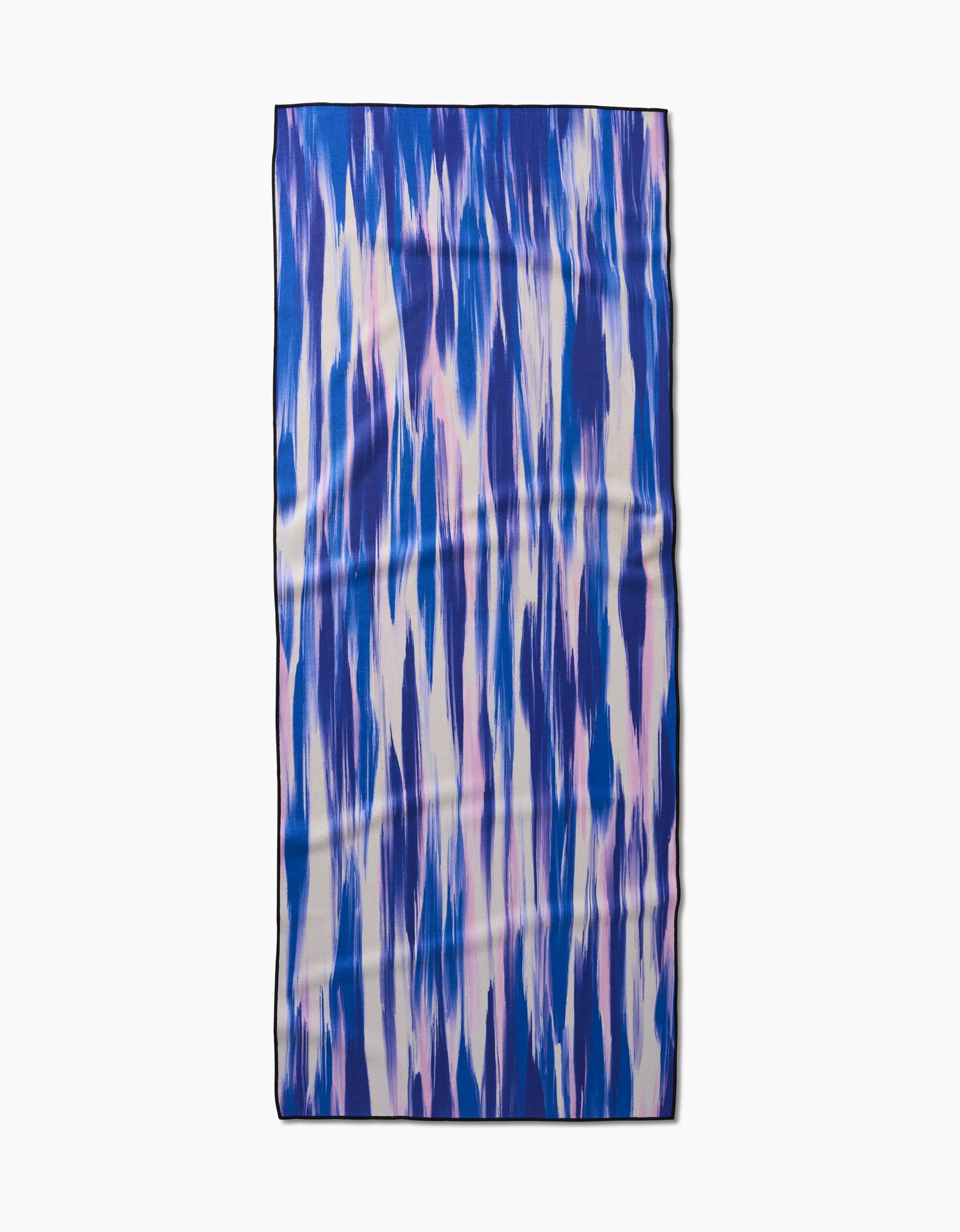 The GEOMETRY Blue Blast yoga towel features a blue, purple, and white watercolor-inspired abstract design and is made from recycled materials.