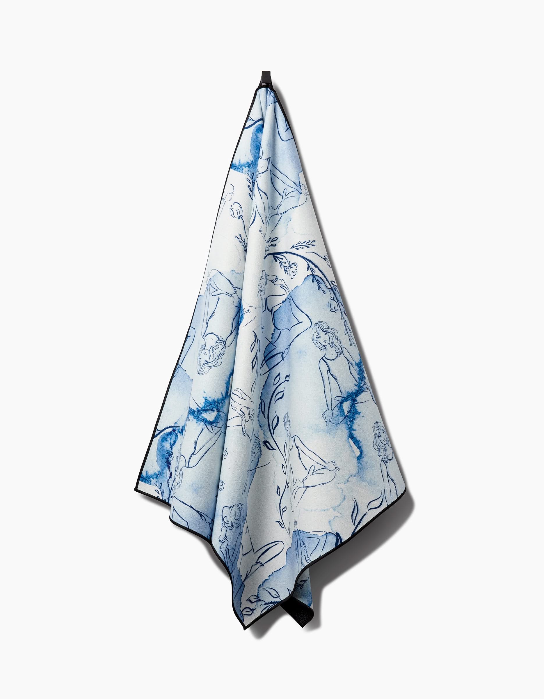 The Breathe In Breathe Out yoga towel by Elena Fay features artistic blue and white line drawings of human figures and abstract shapes, shown hanging from a hook against a plain white background.