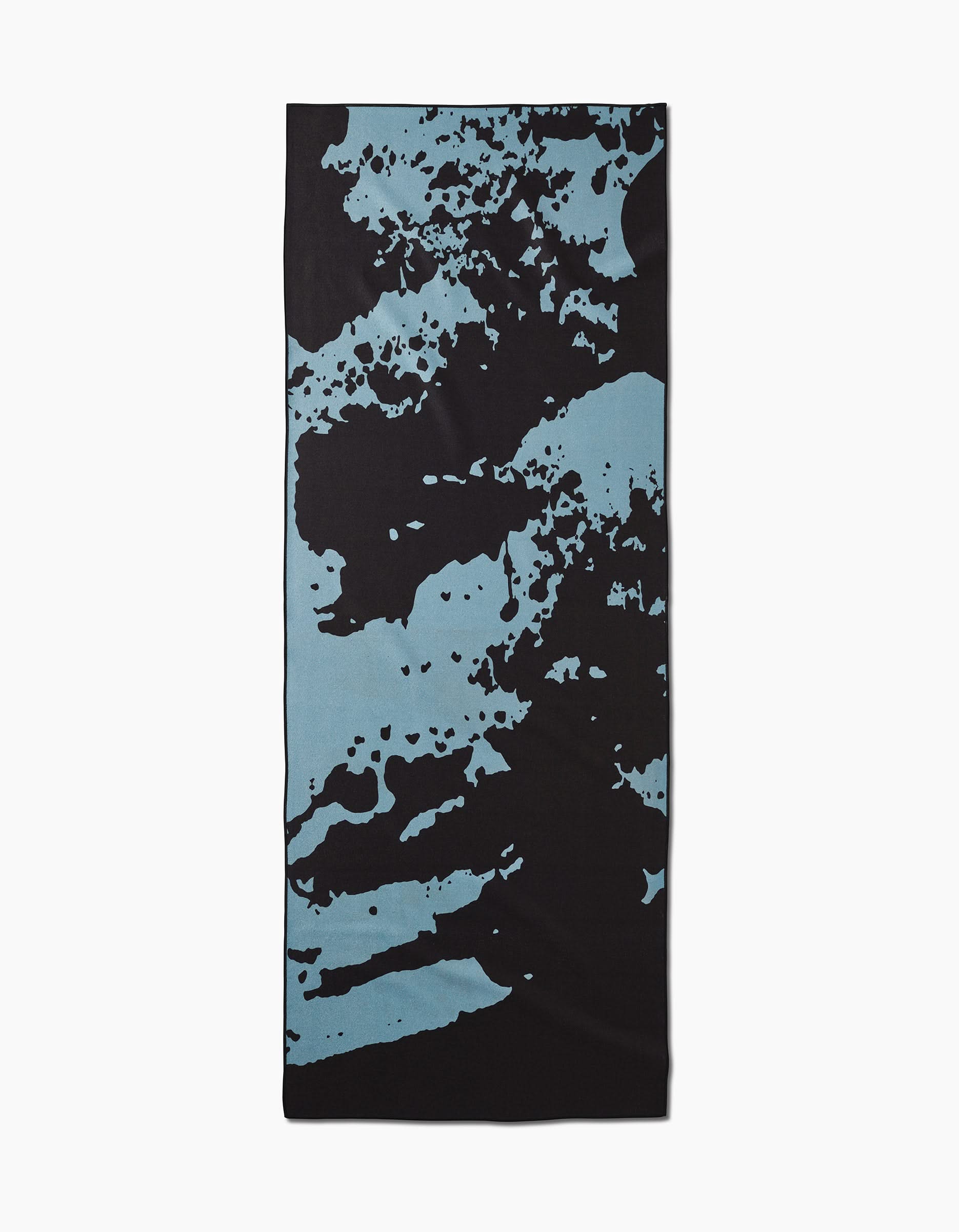 The Cole Strem Brush Stroke yoga towel features an abstract, modern black background with uneven light blue splashes. Made from recycled materials, this rectangular towel delivers a dynamic look.