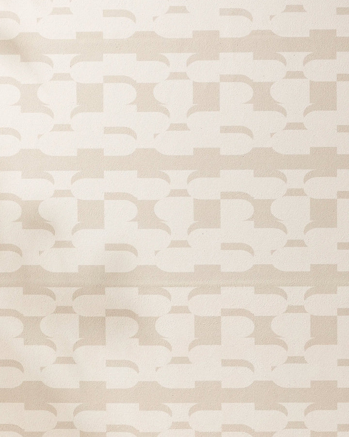 The Geometry Buttons yoga towel features a beige and cream geometric pattern with interlocking shapes on a textured, non-slip surface for a subtle, abstract, and modern look.