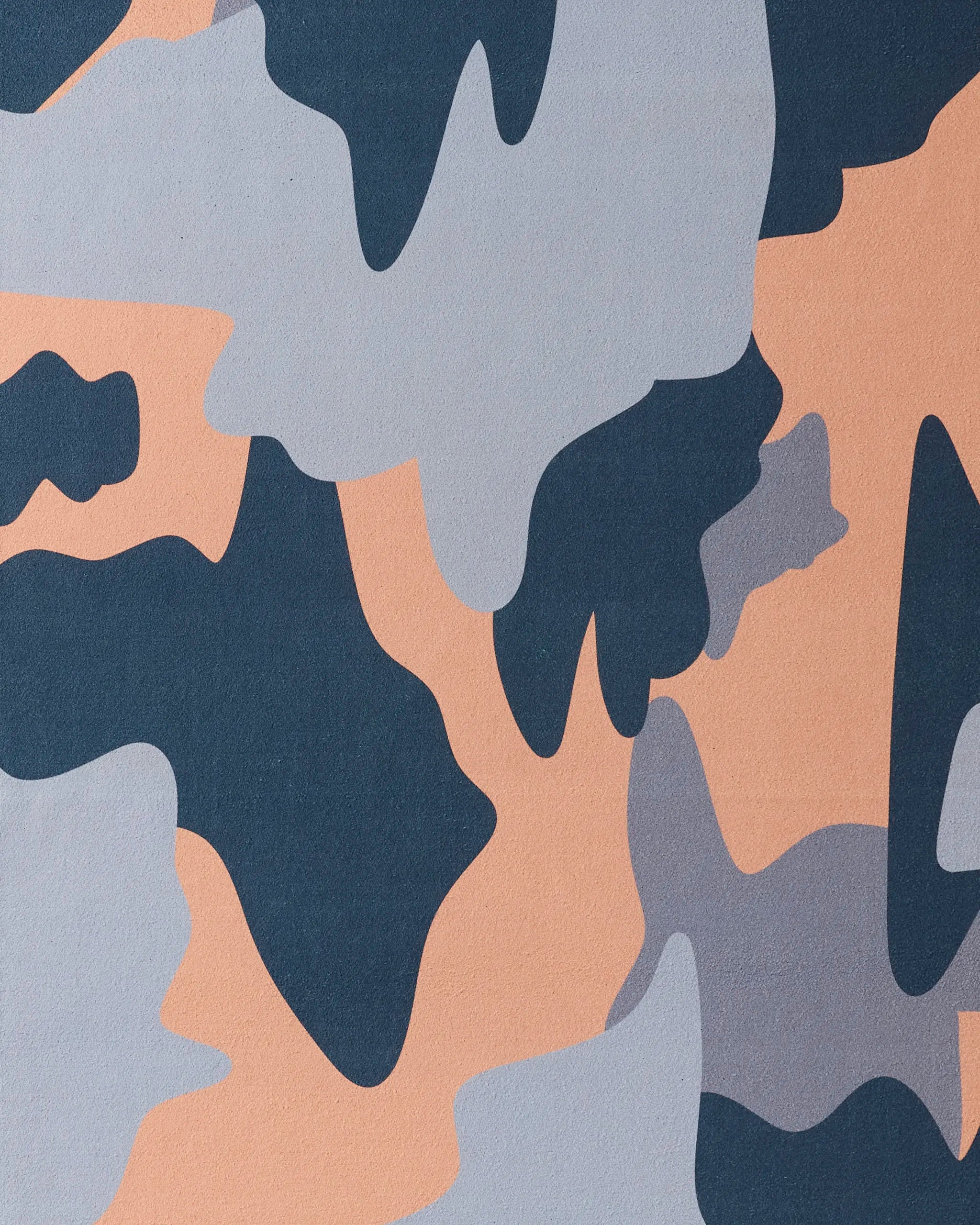The Camo yoga towel by GEOMETRY features an abstract pattern of dark blue, gray, and beige shapes inspired by classic military camo—crafted from recycled materials for eco-friendly style.