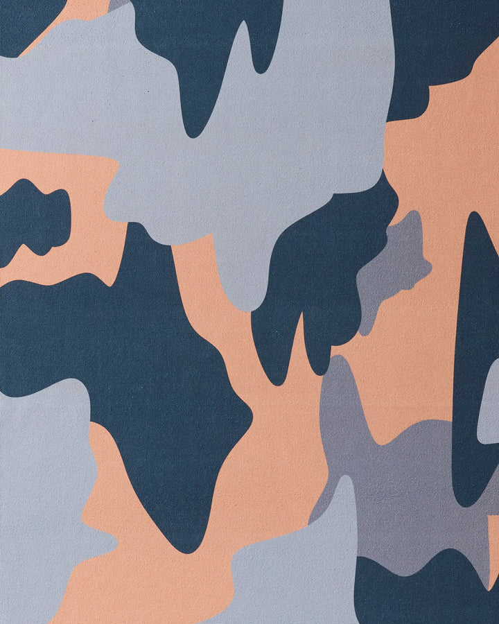The Camo yoga towel by GEOMETRY features an abstract pattern of dark blue, gray, and beige shapes inspired by classic military camo—crafted from recycled materials for eco-friendly style.