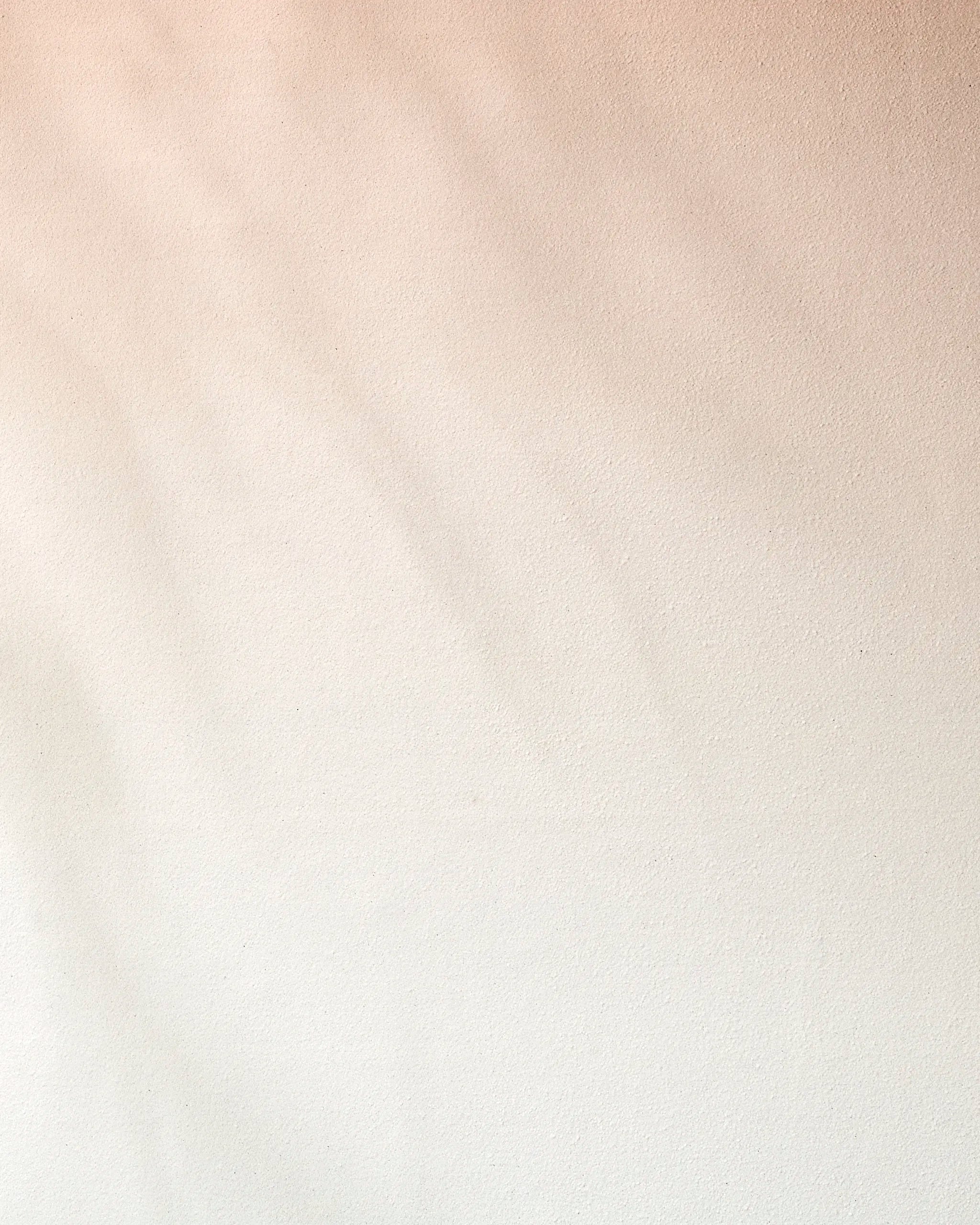 Lightly textured beige wall with soft shadows and a smooth gradient from light tan to off-white, evoking the calming feel of a recycled GEOMETRY Core yoga towel. No distinct patterns or objects visible.