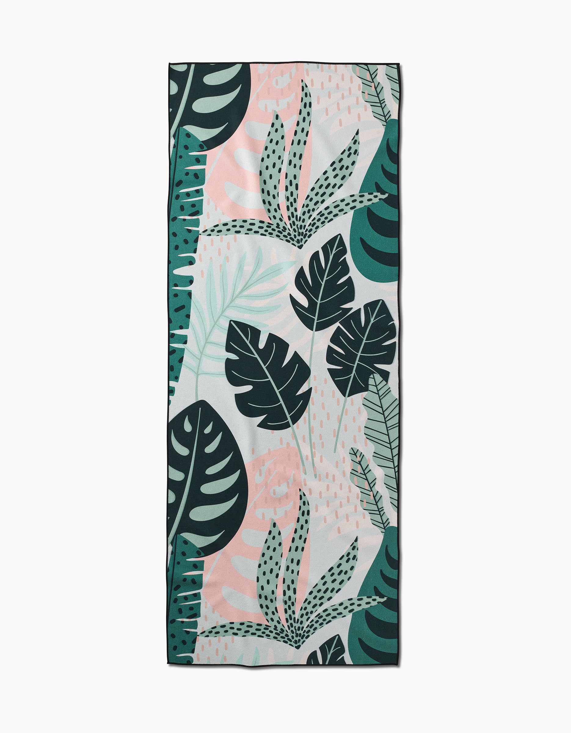 The GEOMETRY Diedre recycled yoga towel is rectangular and features a tropical leaf pattern in green, pink, and white with abstract accents on a light background.
