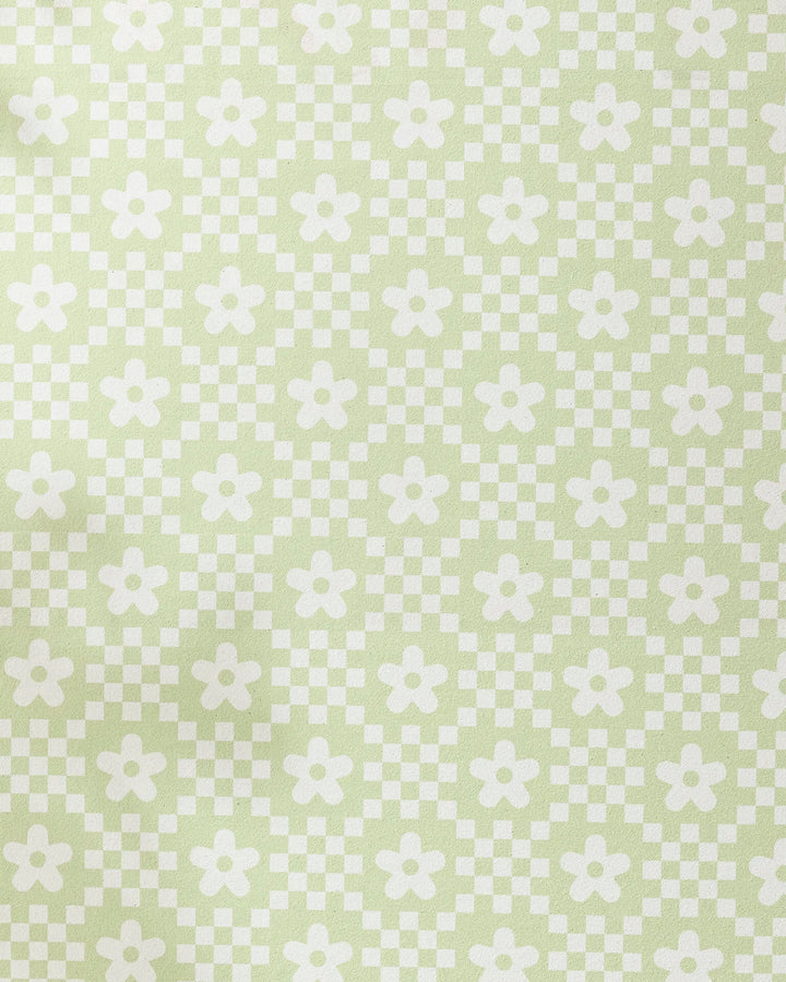 The GEOMETRY Floral Check recycled yoga towel features a retro-inspired pattern of white flowers and checkerboard squares on pale green, offering a symmetrical and stylish design.