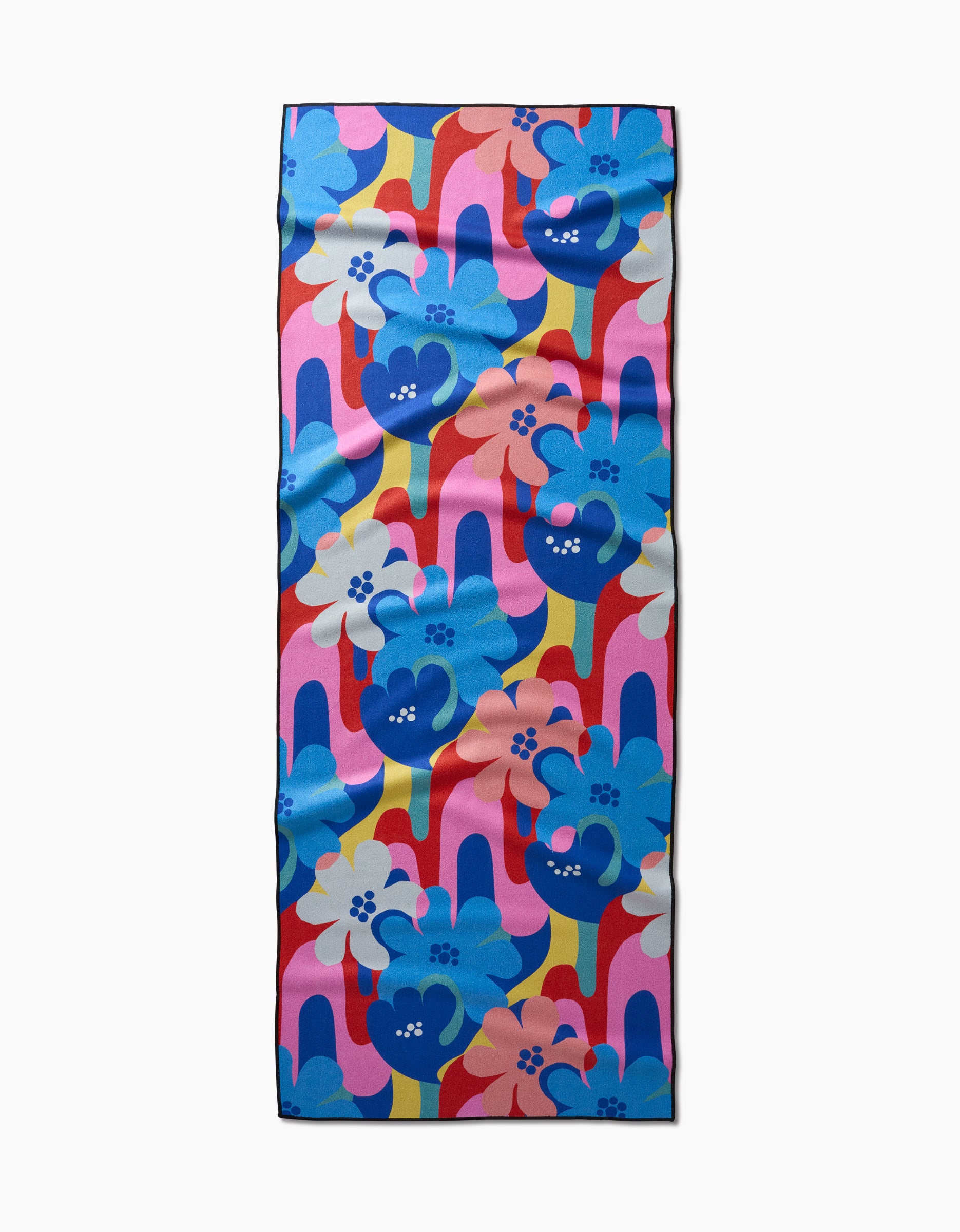 The Flower Powers yoga towel by Masha Volnova features bold blue, pink, red, and yellow retro floral patterns with large flowers and wavy lines on a white background plus a lightly wrinkled texture.