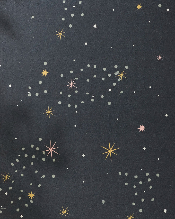 Galaxy Burst by Ash Cascade features a dark backdrop with white, gray, orange, and pink star-like dots—creating a stylized night sky ideal for inspiring recycled or non-slip yoga towel designs.