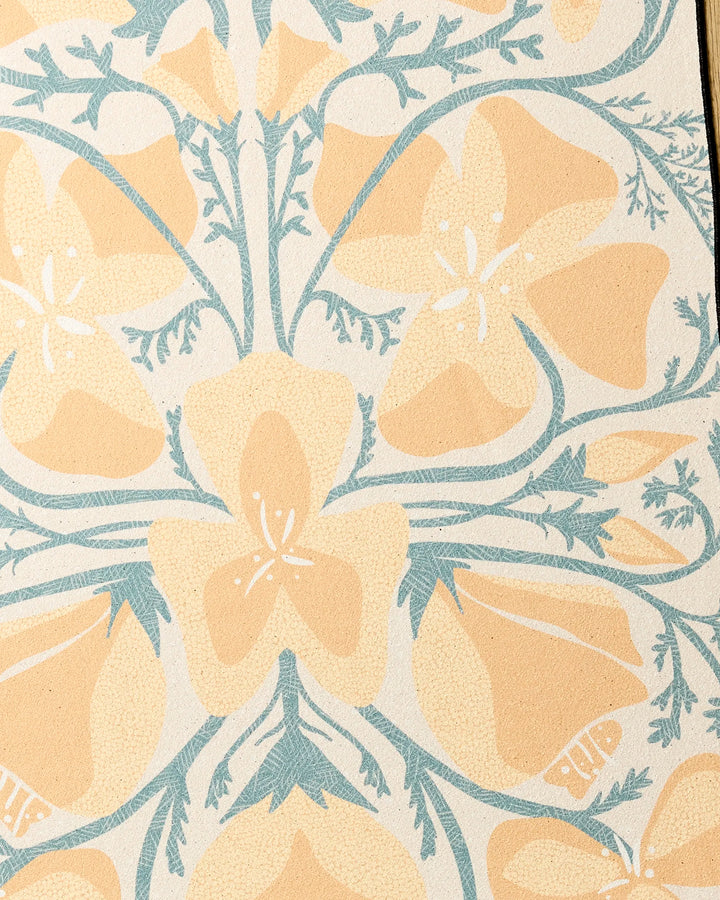 A close-up of Golden Poppy by Julianne Haness shows large pale yellow flowers with white accents and light blue stems on a cream background, featured on this recycled yoga towel.