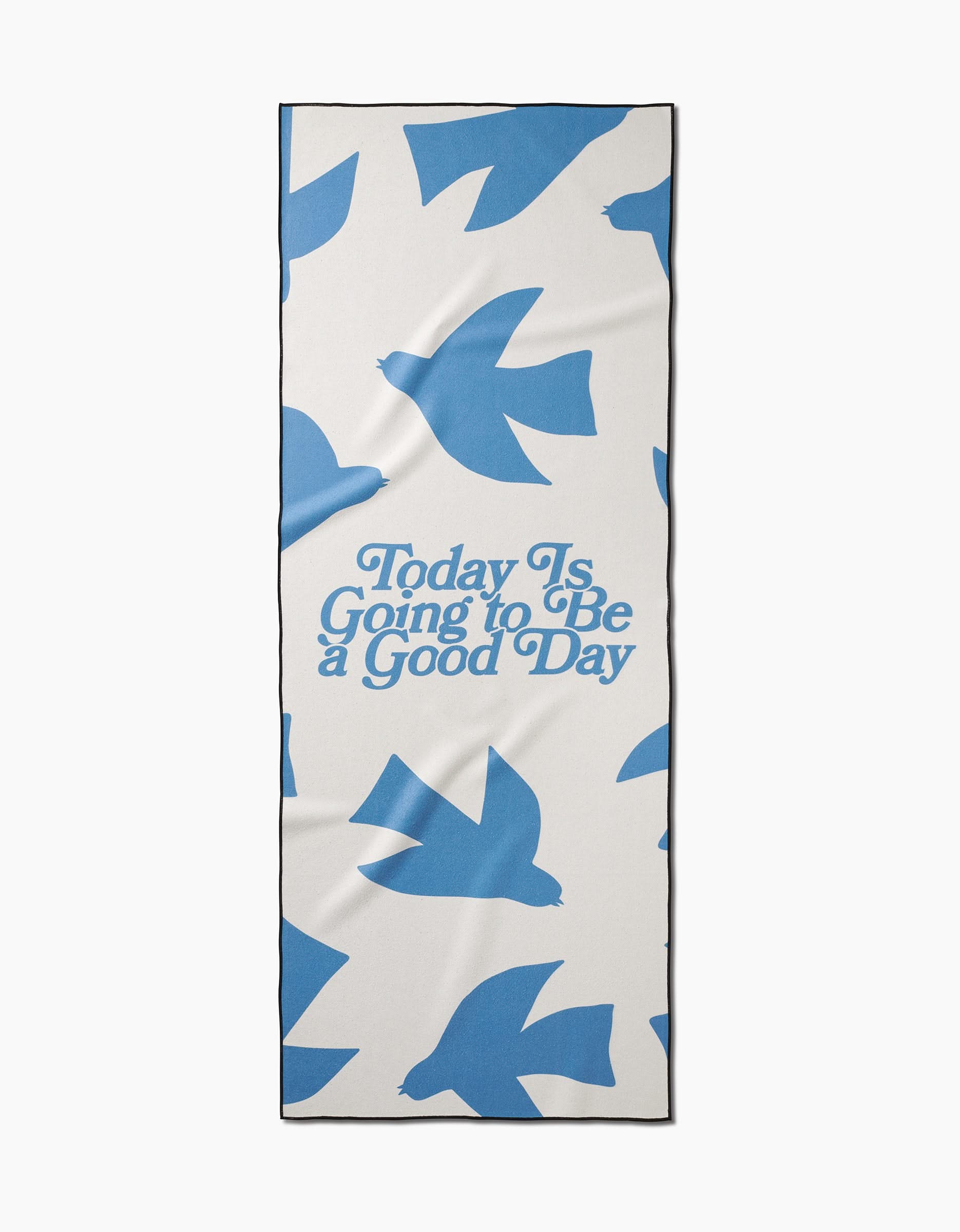 The Good Day yoga towel by Quotes by Christie is a rectangular, white towel made from recycled materials with blue bird silhouettes and the phrase Today Is Going to Be a Good Day printed in blue.