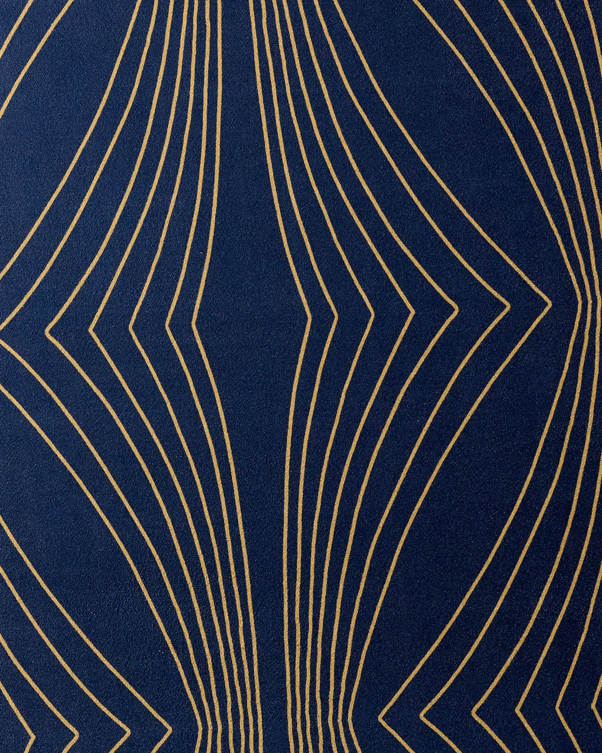 The Hera non-slip yoga towel by Amy MacCready features a dark blue background with curved, symmetrical gold lines forming elegant geometric waves—a perfect blend of style and function.