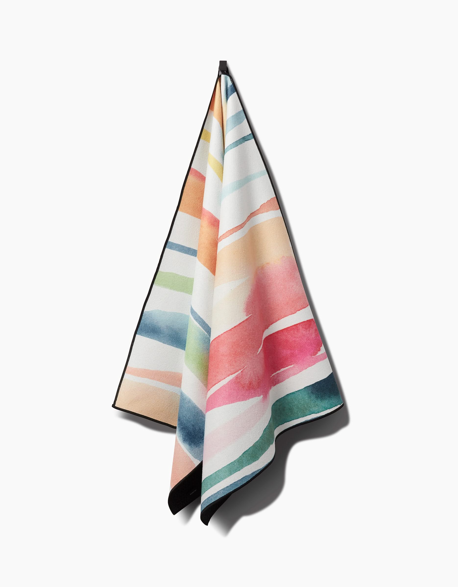The Sara Mari Lakeside yoga towel, made from recycled materials, features vibrant horizontal watercolor stripes in pink, green, blue, orange, and yellow and is displayed against a white background.