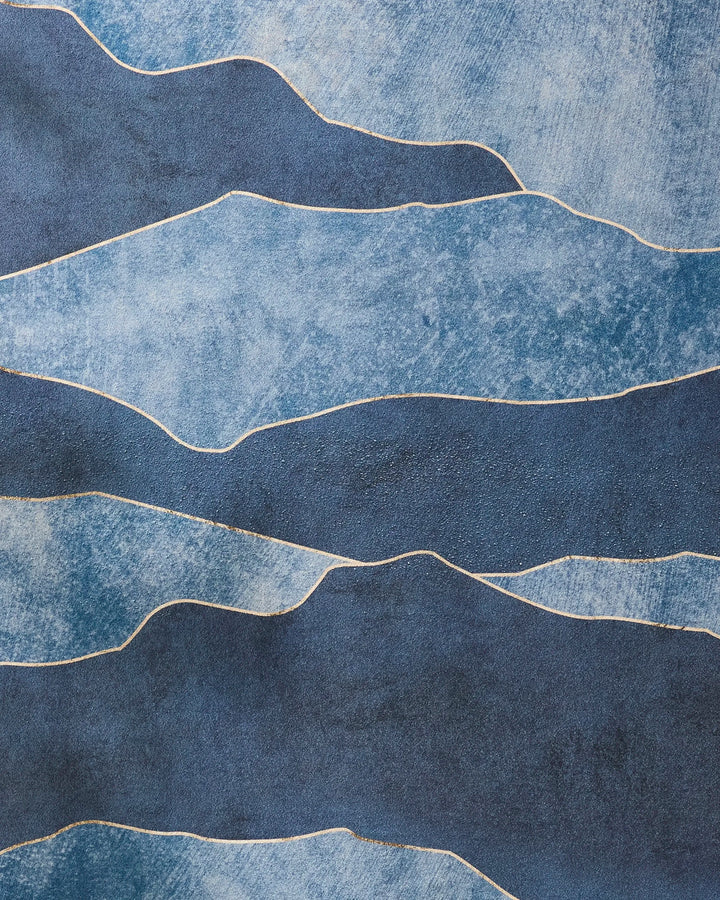 The GEOMETRY "Lined With Gold" features irregular, wavy blue bands with thin white lines, resembling a slip-resistant yoga towel or flowing water, and has a rough, painterly texture.