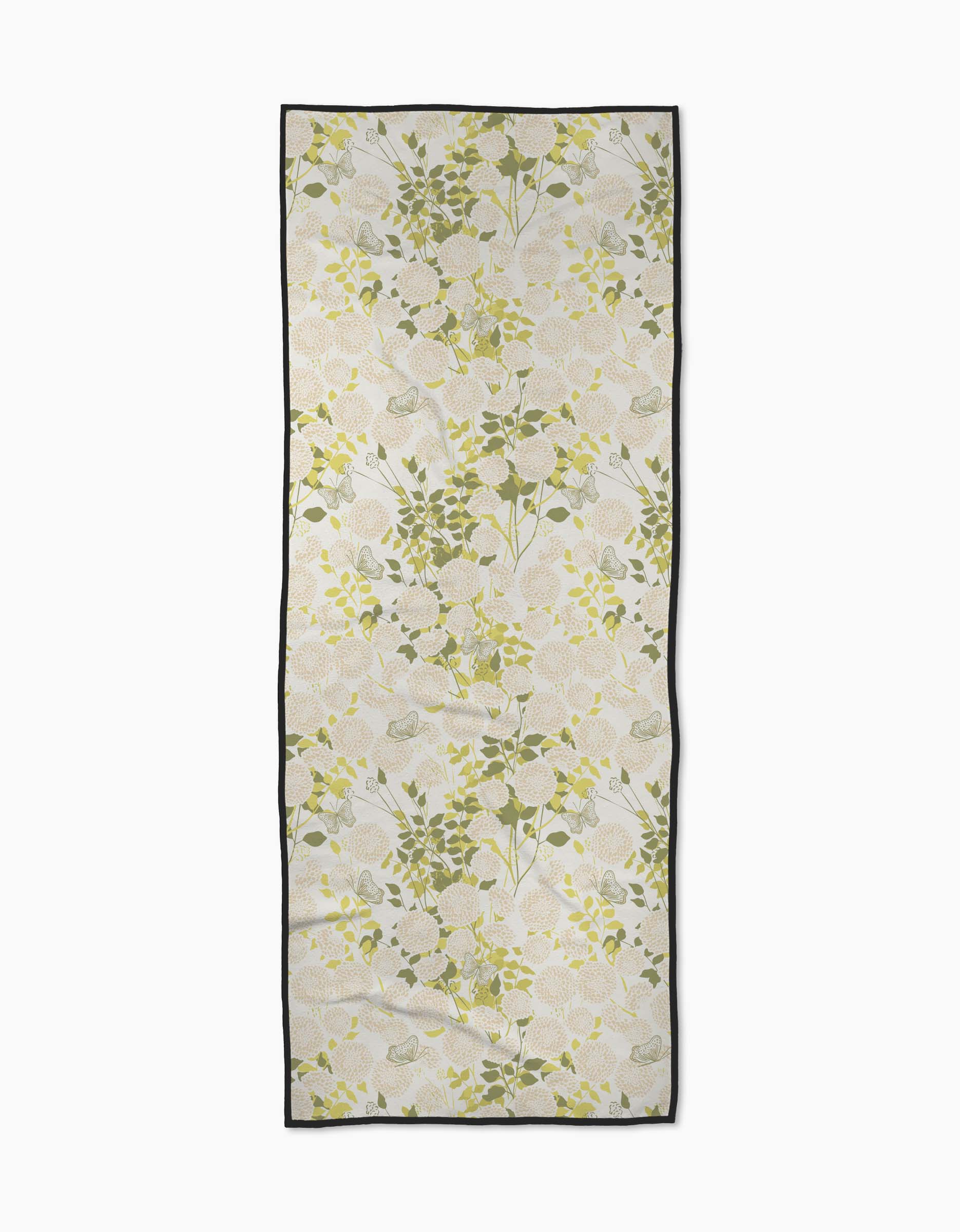 The Lush Garden yoga towel by Second Nature Studio features a rectangular non-slip design with a green and yellow floral pattern and black border, shown on a plain white background.