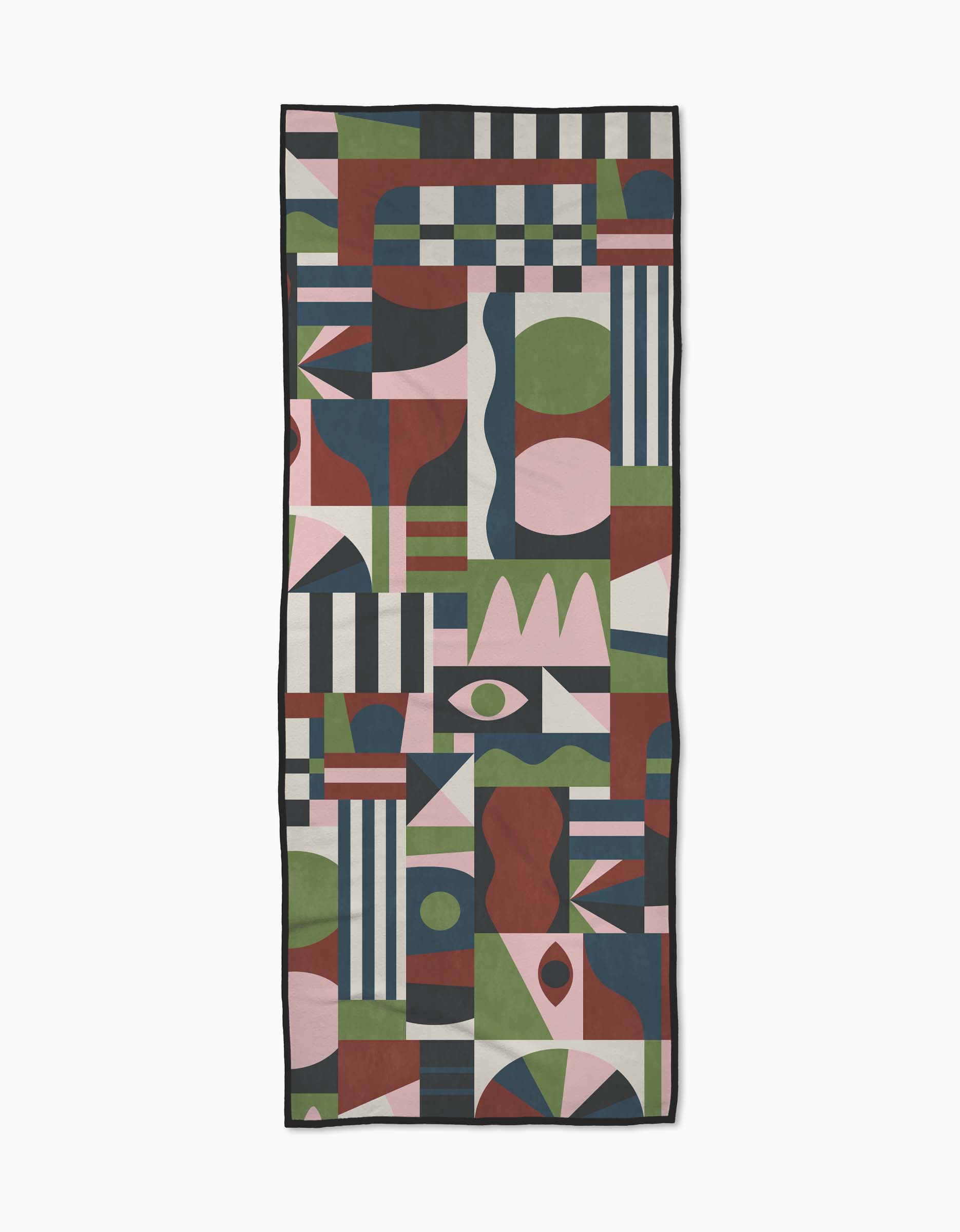 The Modern Bauhaus Mood yoga towel by Claire Iglesias is a rectangular, non-slip towel with a colorful abstract geometric pattern in green, red, pink, blue, and white.