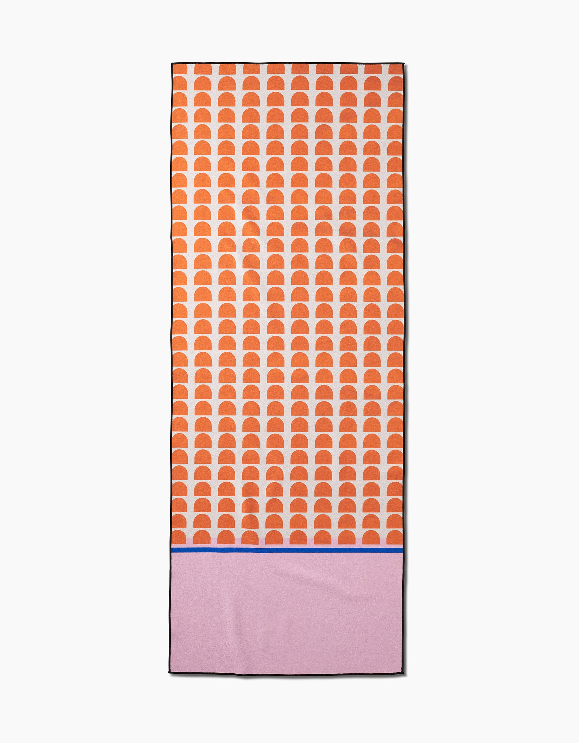 The Pink Illusion yoga towel by Happy Hemera is rectangular, made from recycled materials, and features orange-white semicircles on the top two-thirds plus a solid pink bottom with a thin blue line.